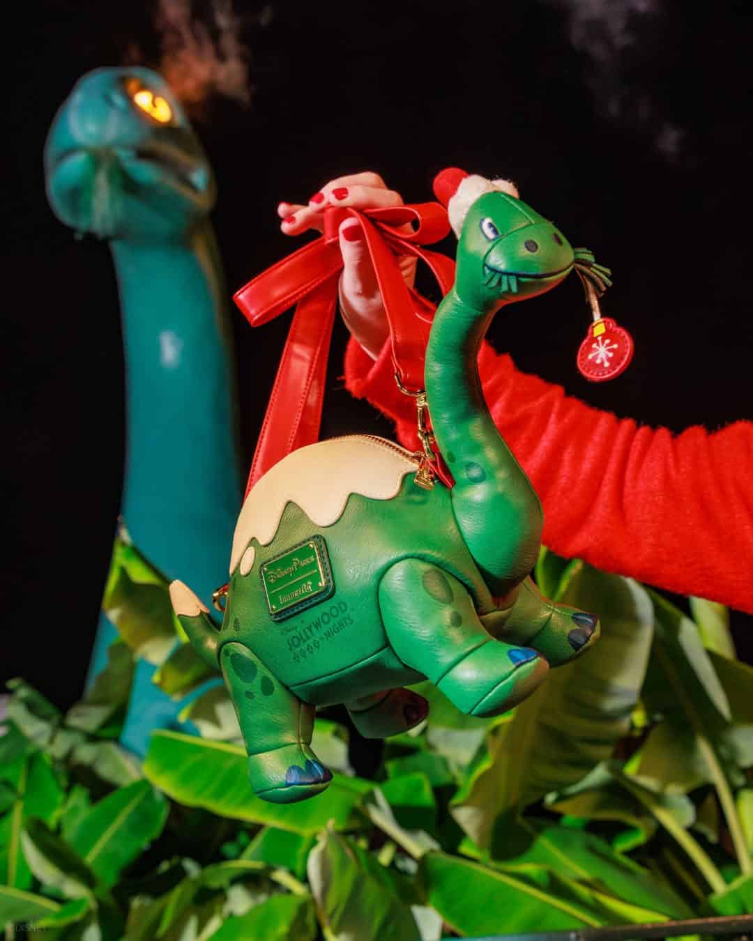 shoulder strap and close up of Gertie Dinosaur bag with Jollywood Nights logo