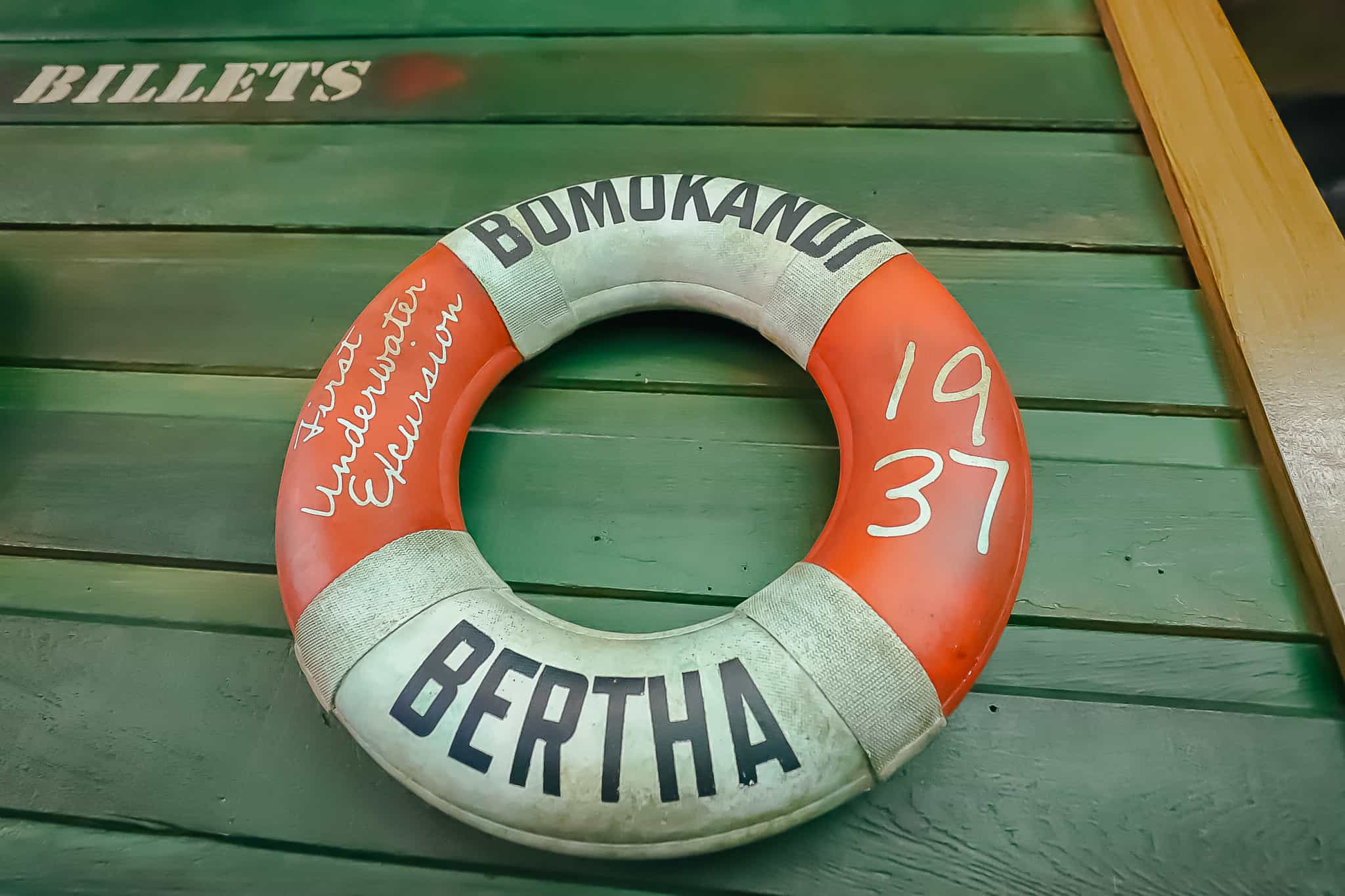 A queue element, life preserver with one of the boats names printed on it. 