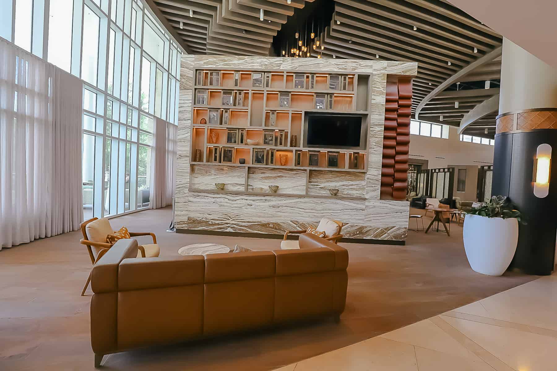 hotel lobby area with large sofa and two chairs 