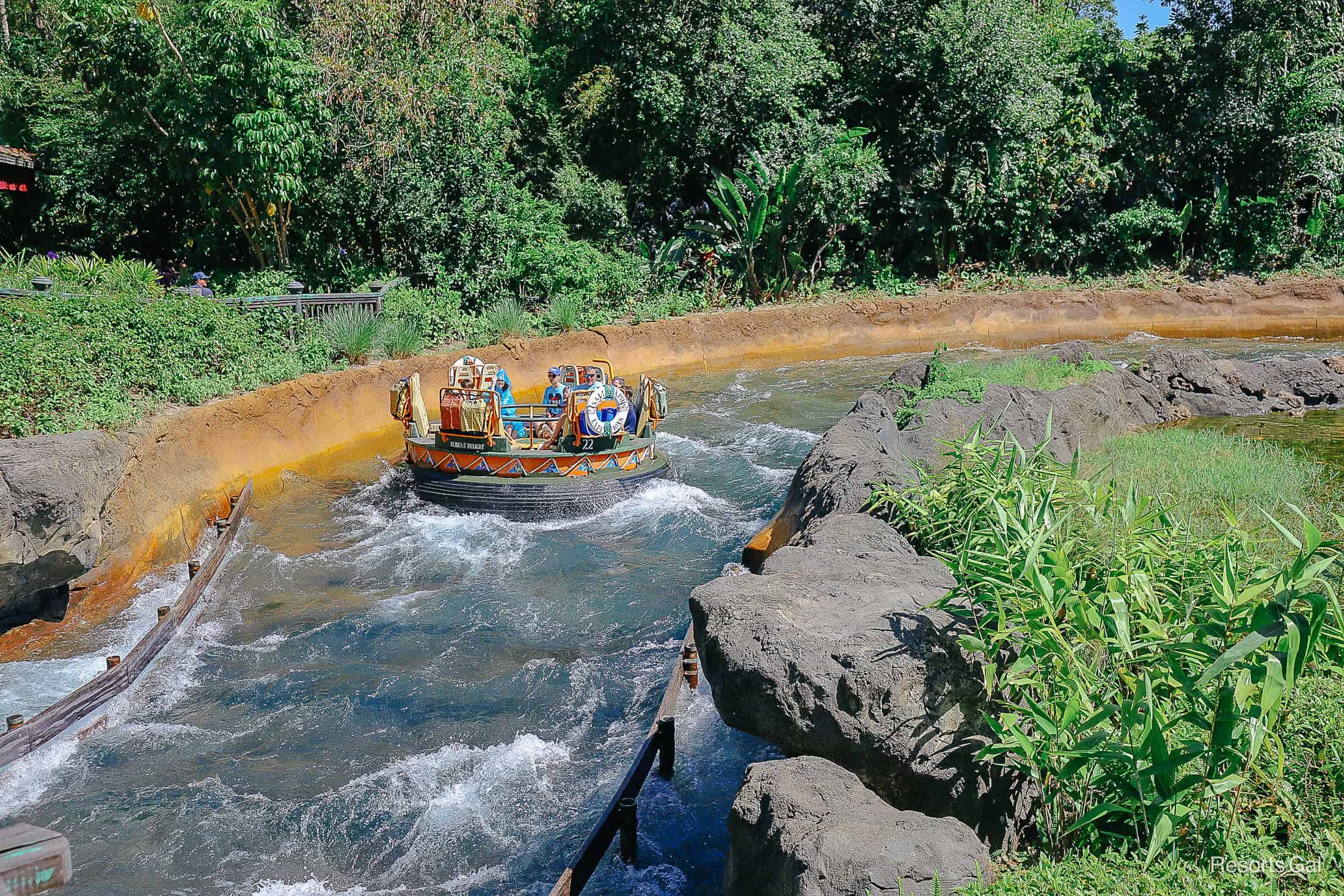 guests floating in a raft down the rapids 