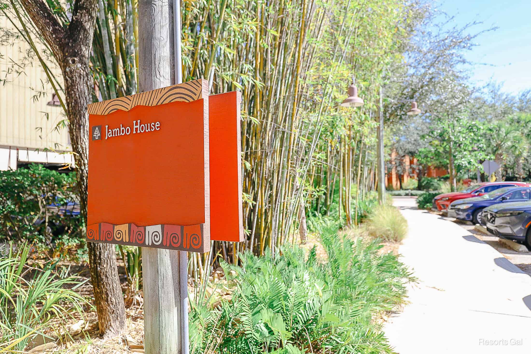 a sign that shows guests to continue straight to reach Jambo House 