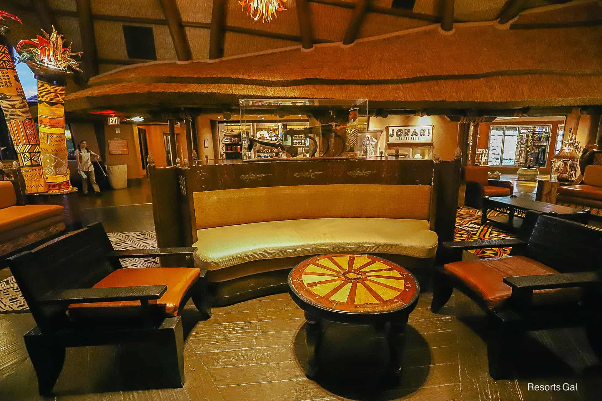a bench with two chairs and a small table in the Kidani Lobby 