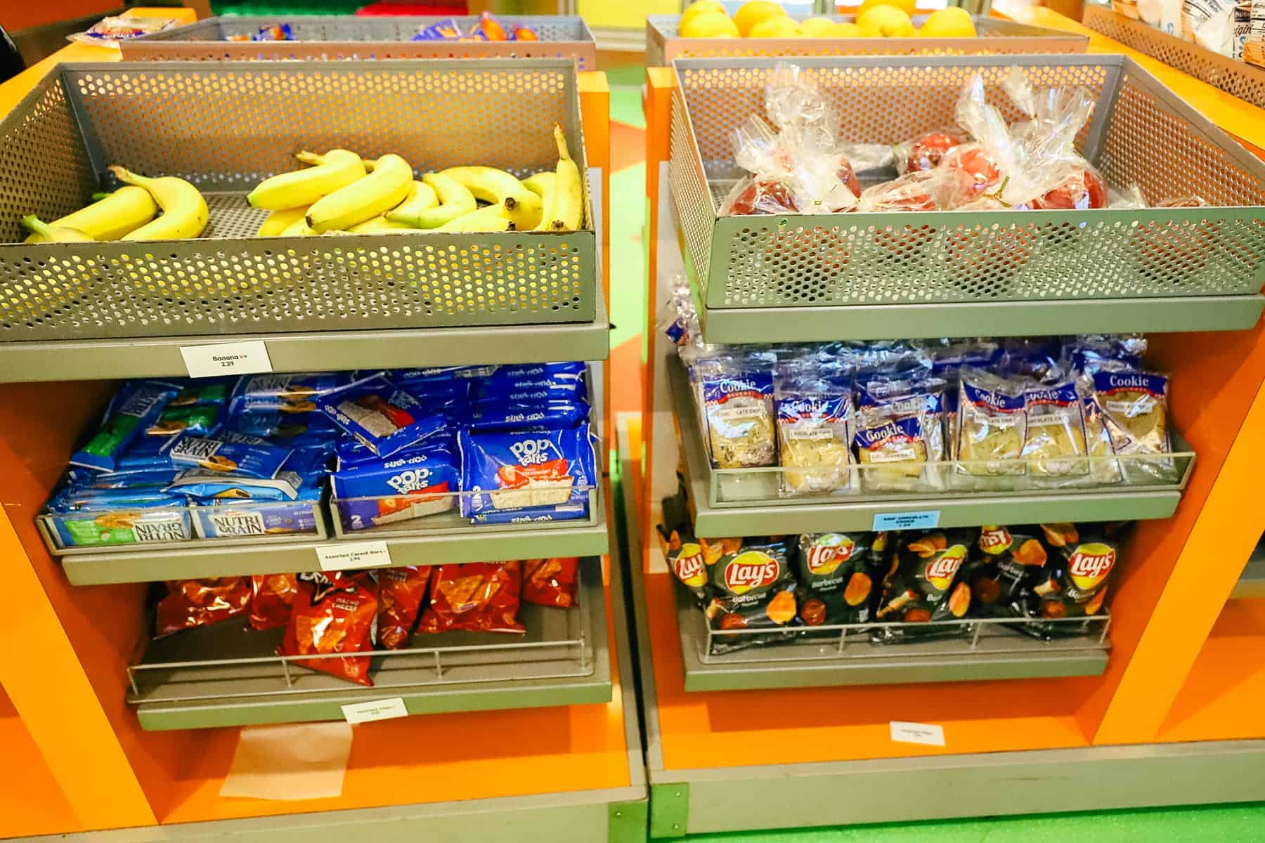 a display with bananas, apples, cookies and breakfast bars 
