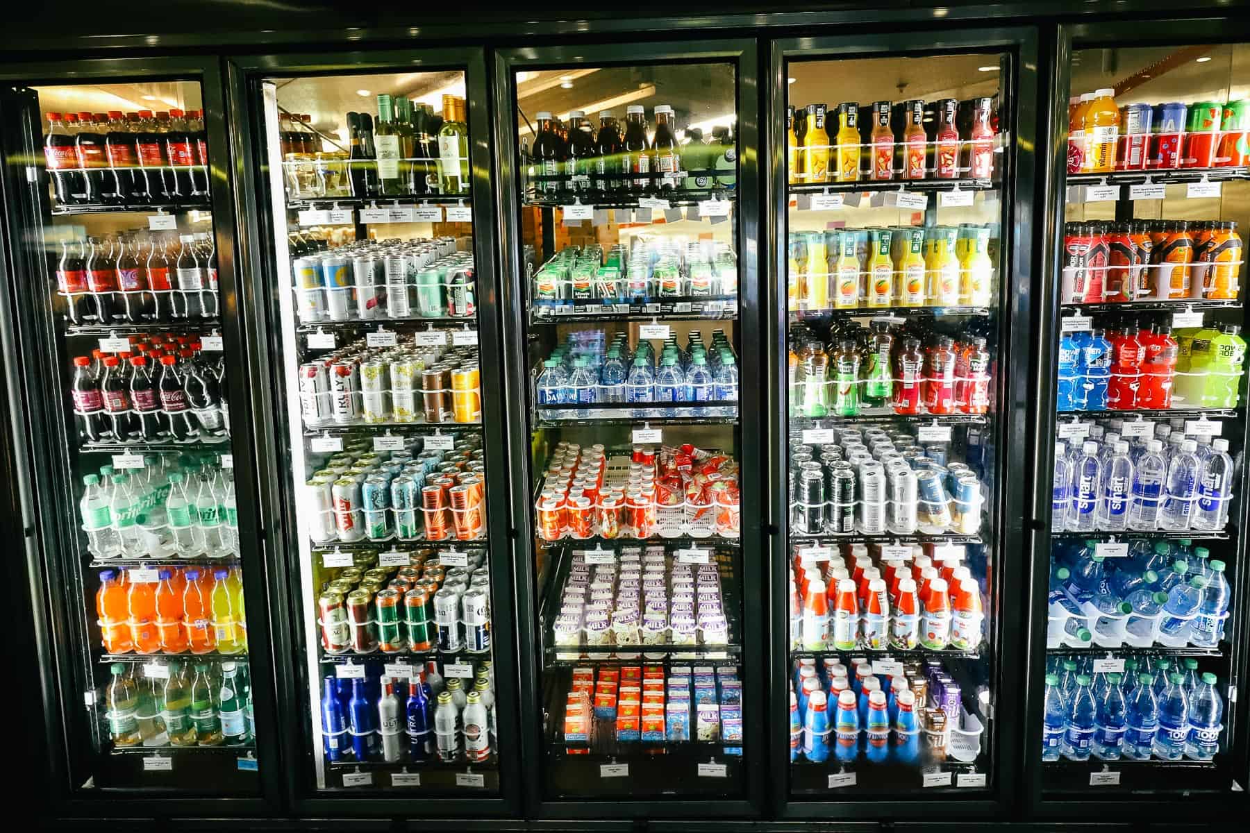 a refrigerated case with beverages like soda, milk, juice, and sports drinks 