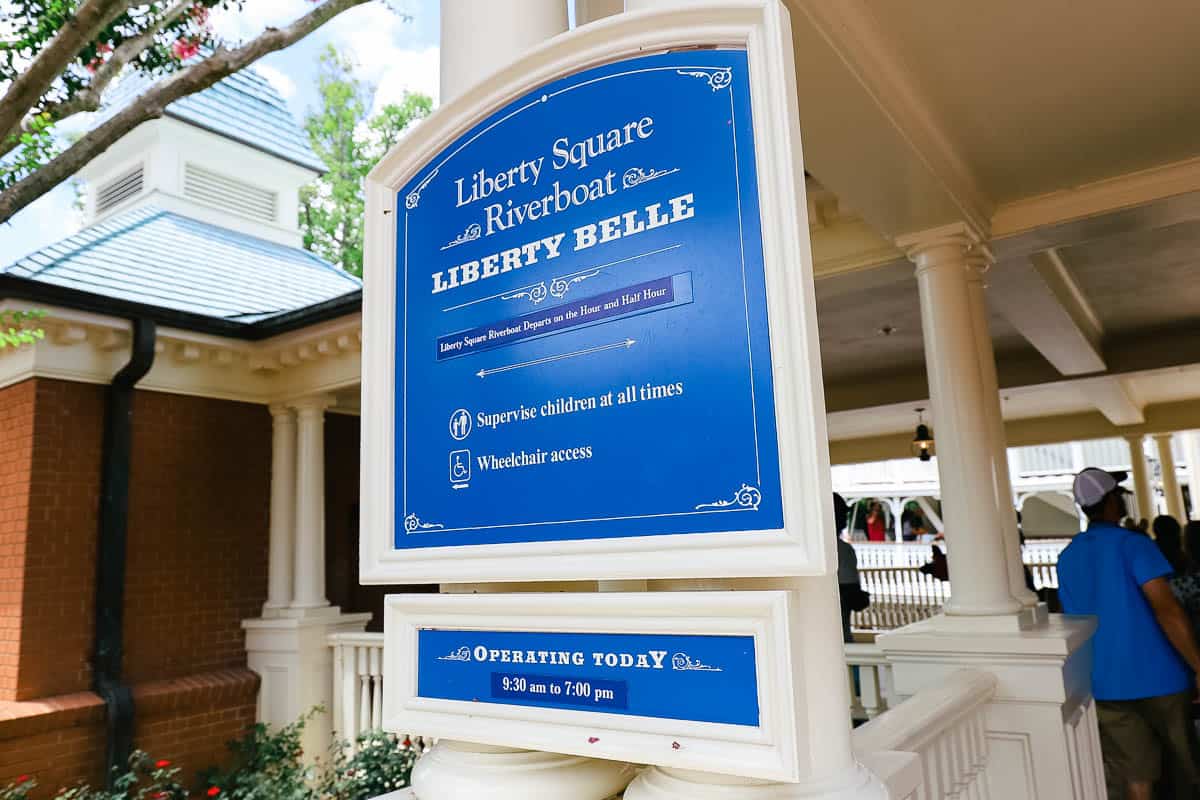 A sign that tells how the Liberty Square Riverboat departs on the hour and half hour. 