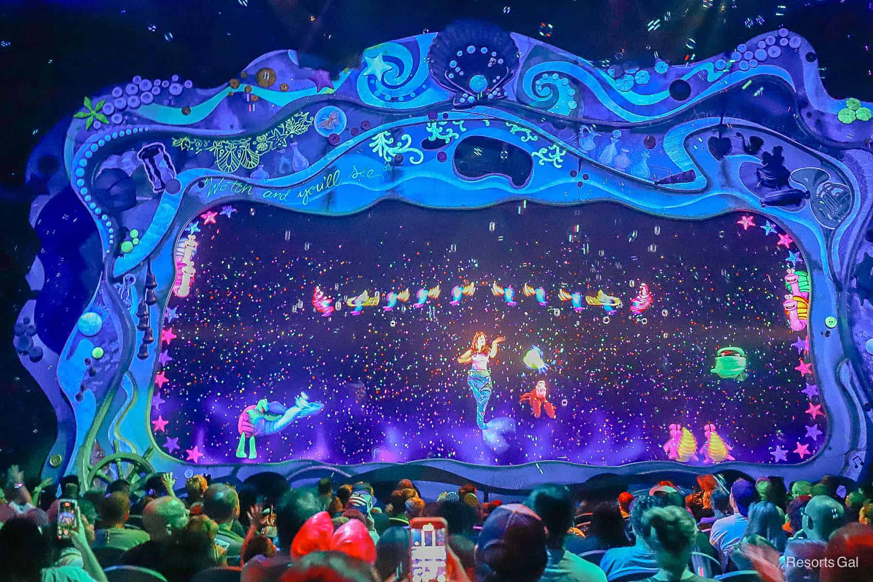 the "Under the Sea" scene with puppets and screen characters in vibrant colors lights up the room