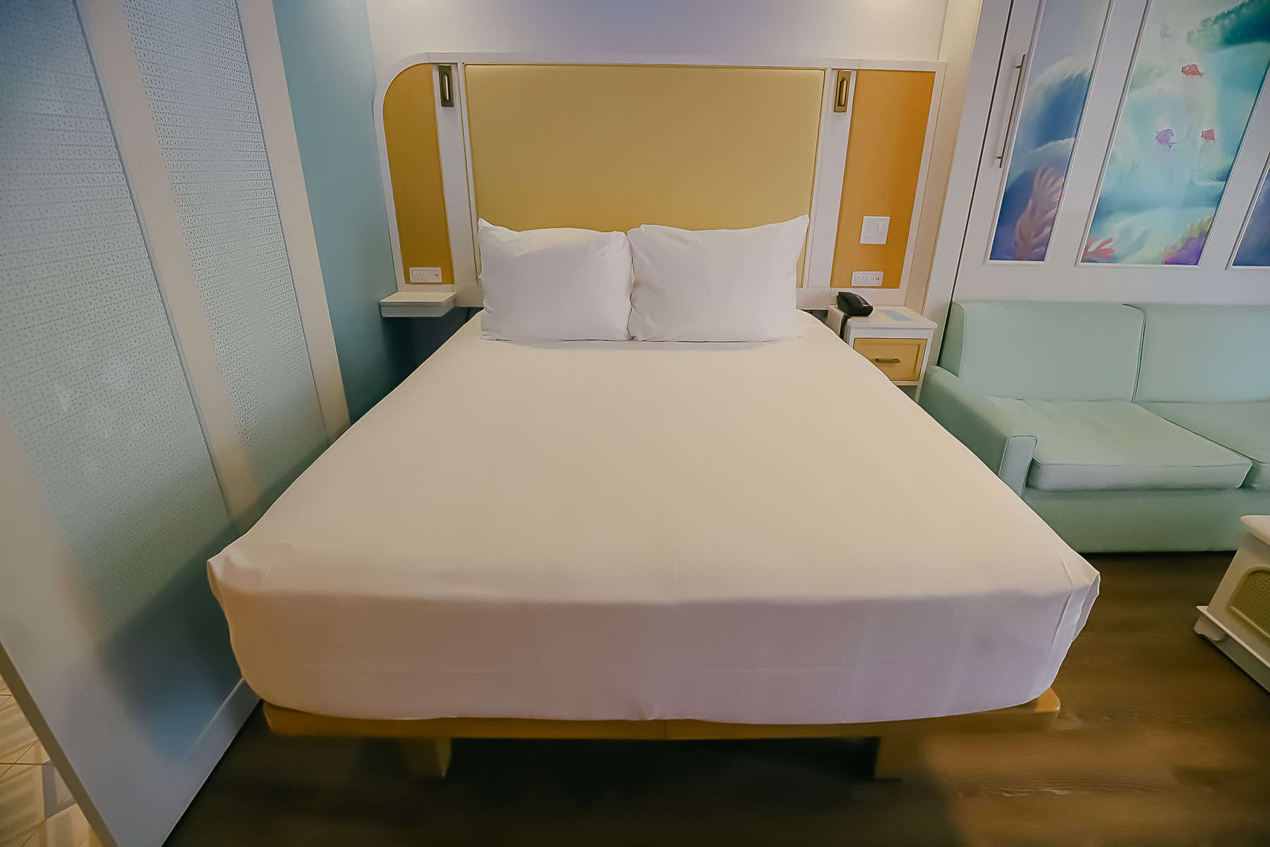 queen-size bed in room at Disney's Caribbean Beach (Trinidad Section)