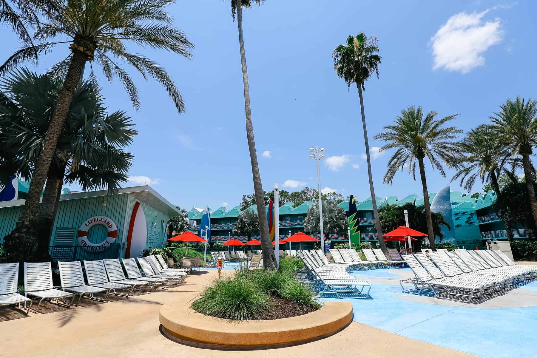 Lounge chairs surrounding the All-Star Sports Surfboard Bay Pool 