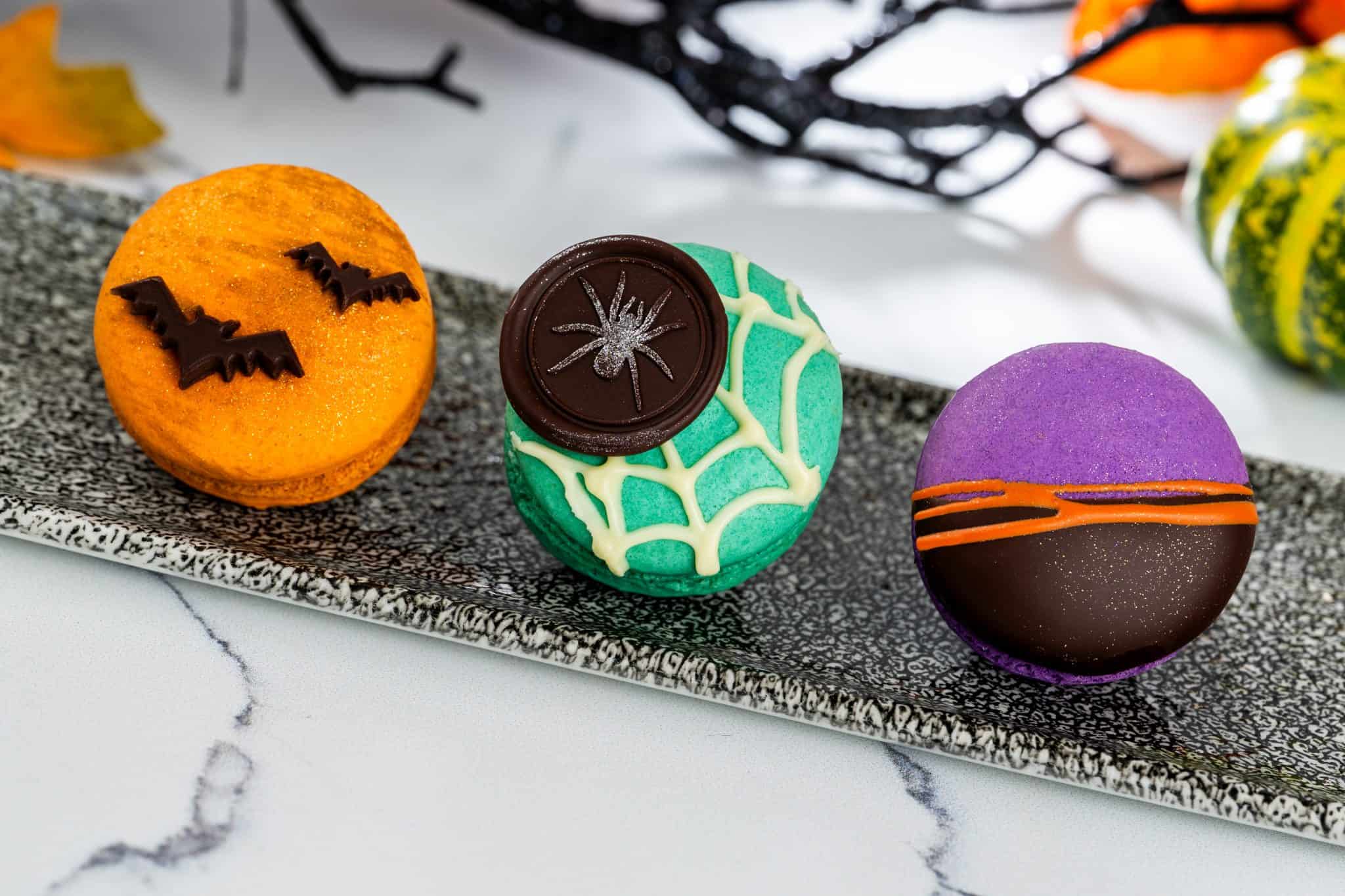a trio of macarons with Halloween decorations