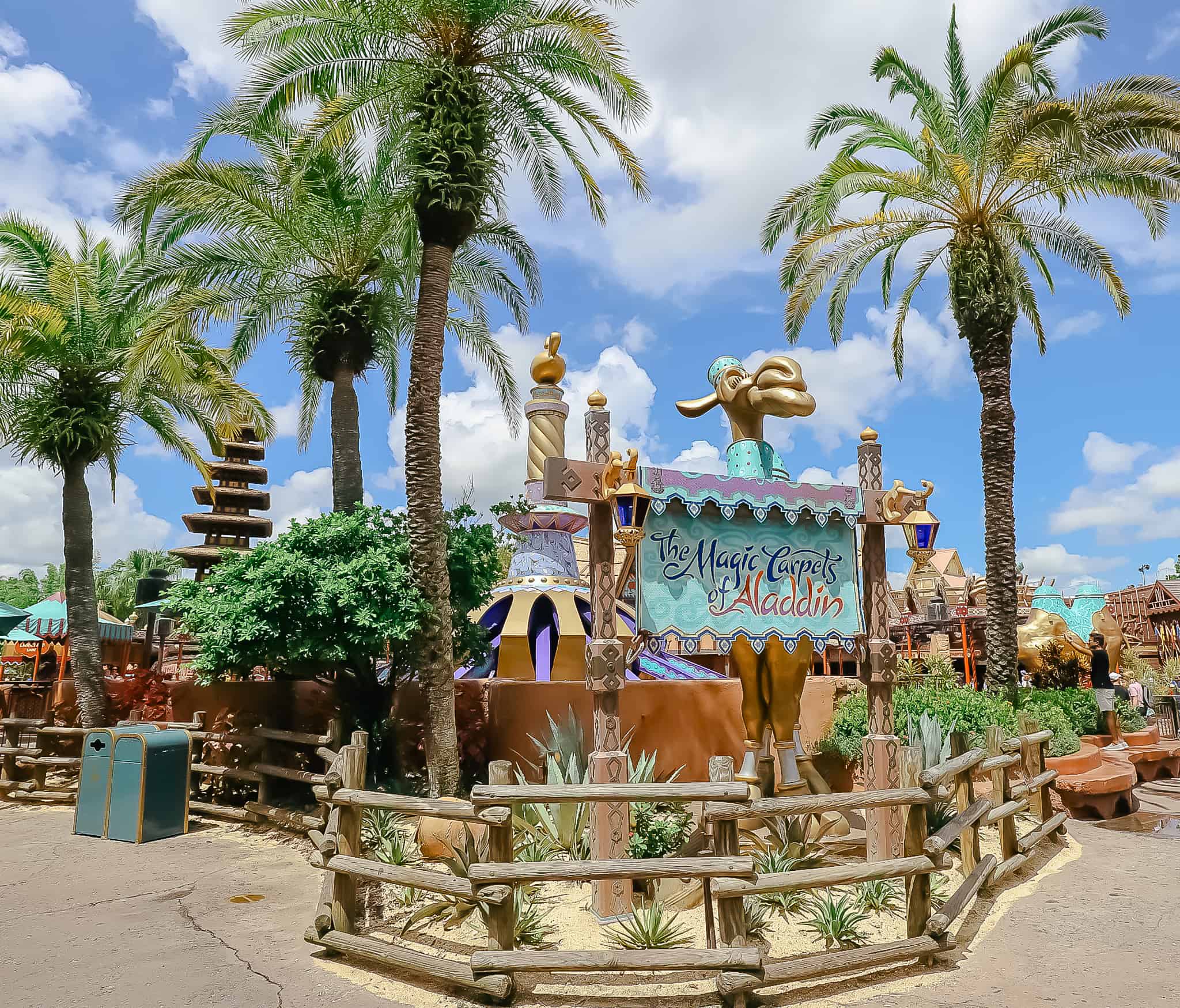 A sign that reads "The Magic Carpets of Aladdin" in front of the attraction. 