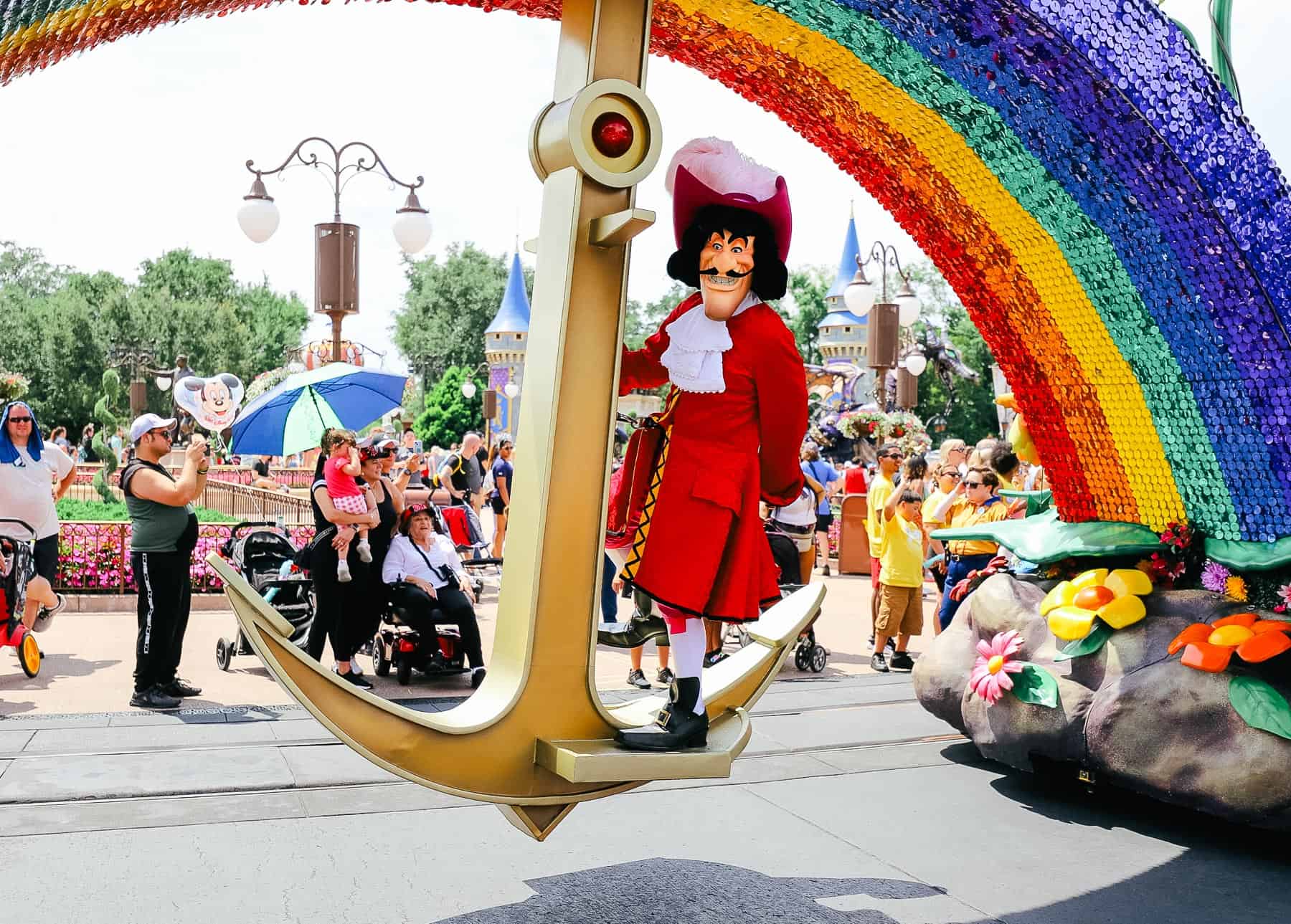 Captain Hook balancing on an anchor in a parade float. 