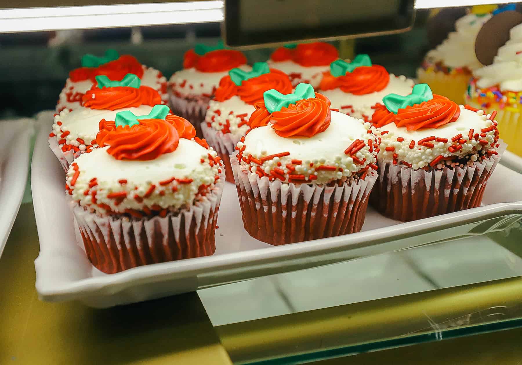 a red velvet cupcake with a red decor and green bow from Main Street Confectionery 