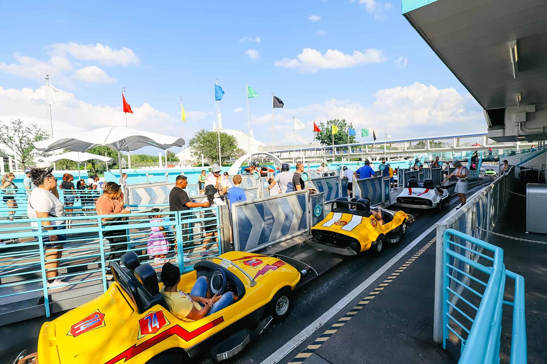 Guests preparing to ride the Tomorrowland Speedway at Magic Kingdom. 