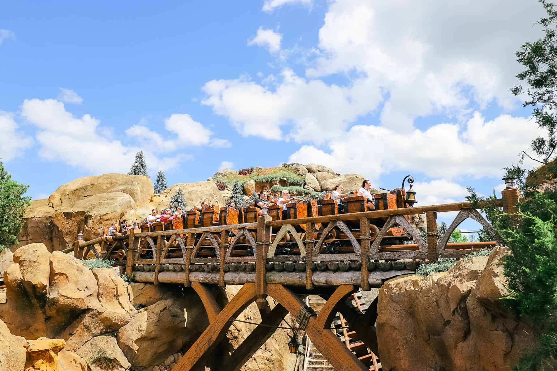 Guests riding Seven Dwarfs Mine Train at Magic Kingdom. 