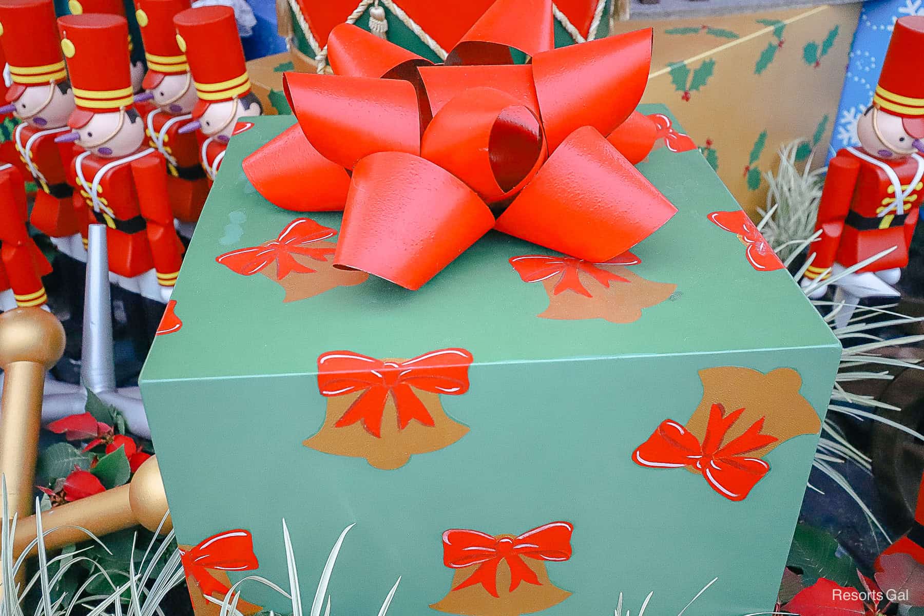 a giant green box with bells and red ribbons 
