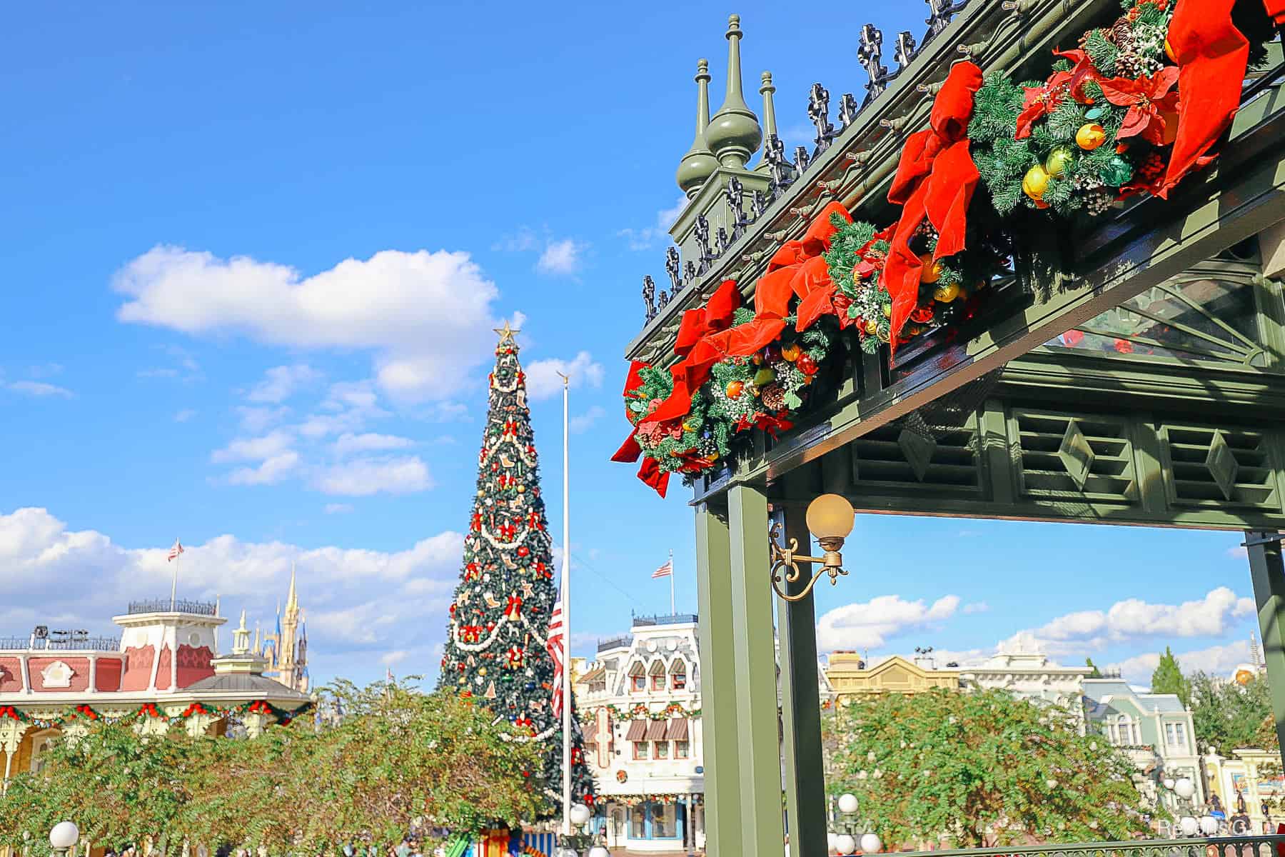 decorative iron work around Main Street Train Station covered with fruit garland and red bows 