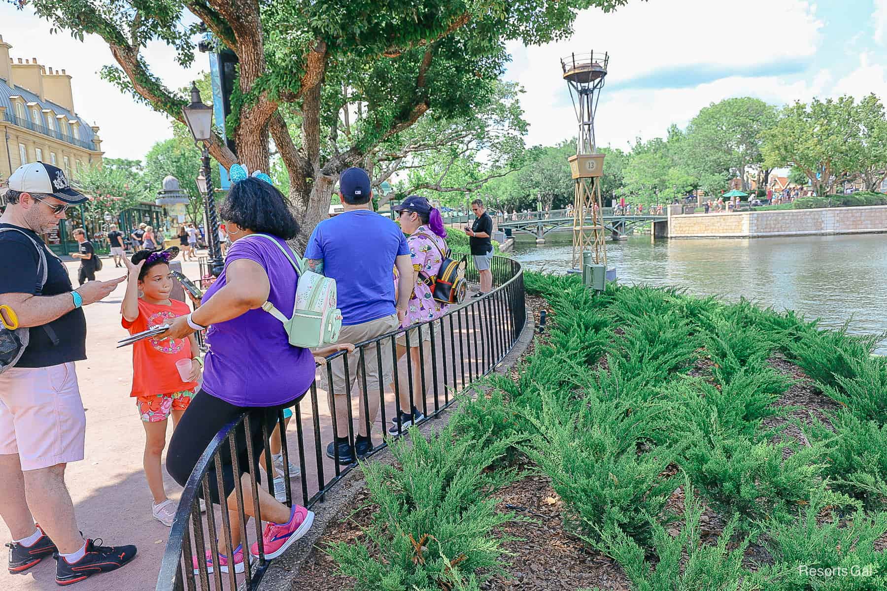 Guests standing in line waiting to meet Belle at Epcot. 