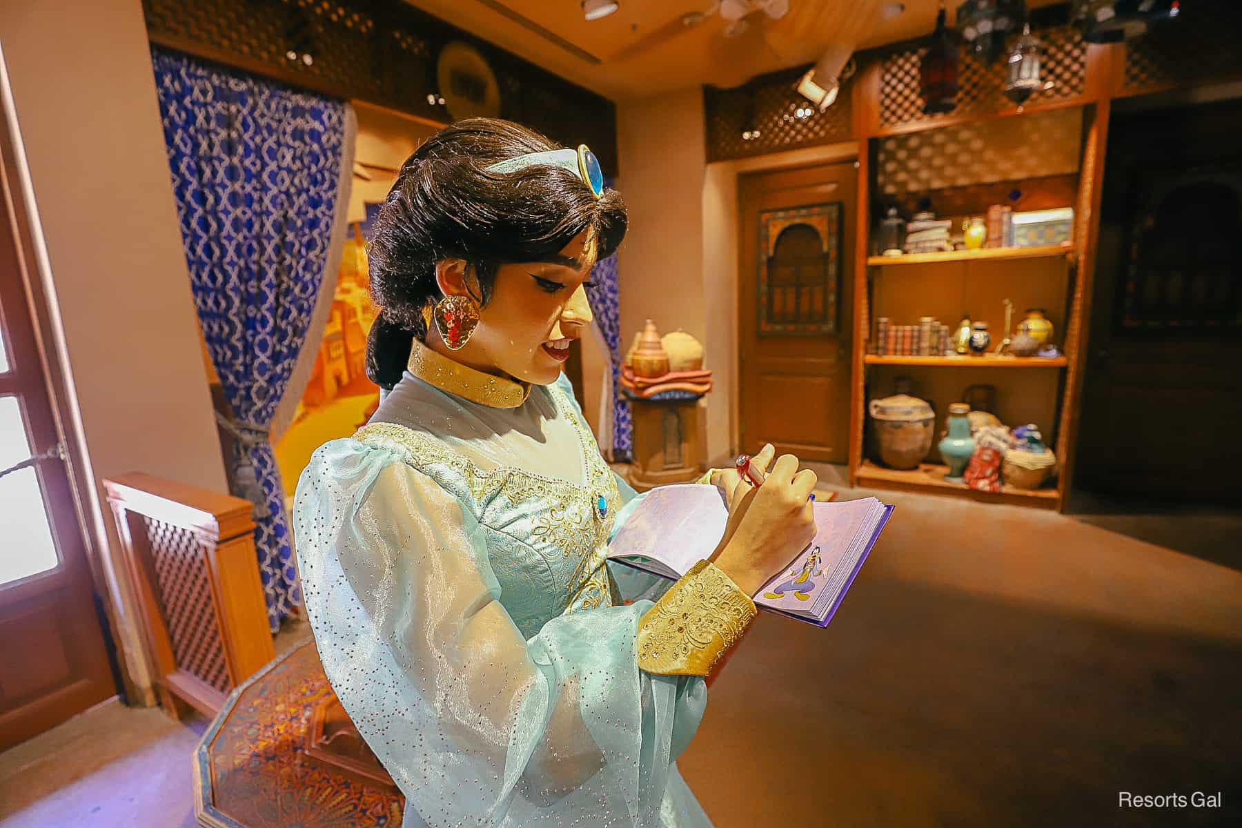 Jasmine signs a character autograph. 