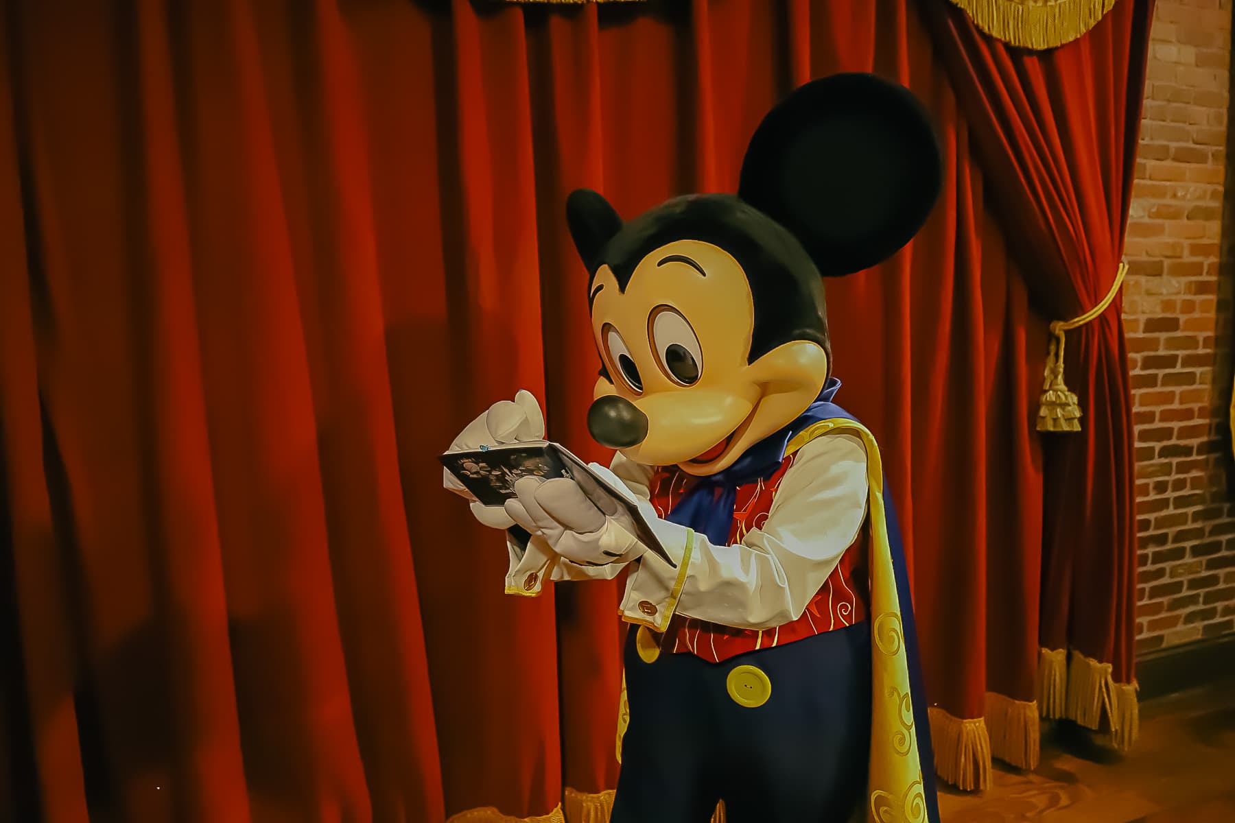 Mickey signs his autograph.