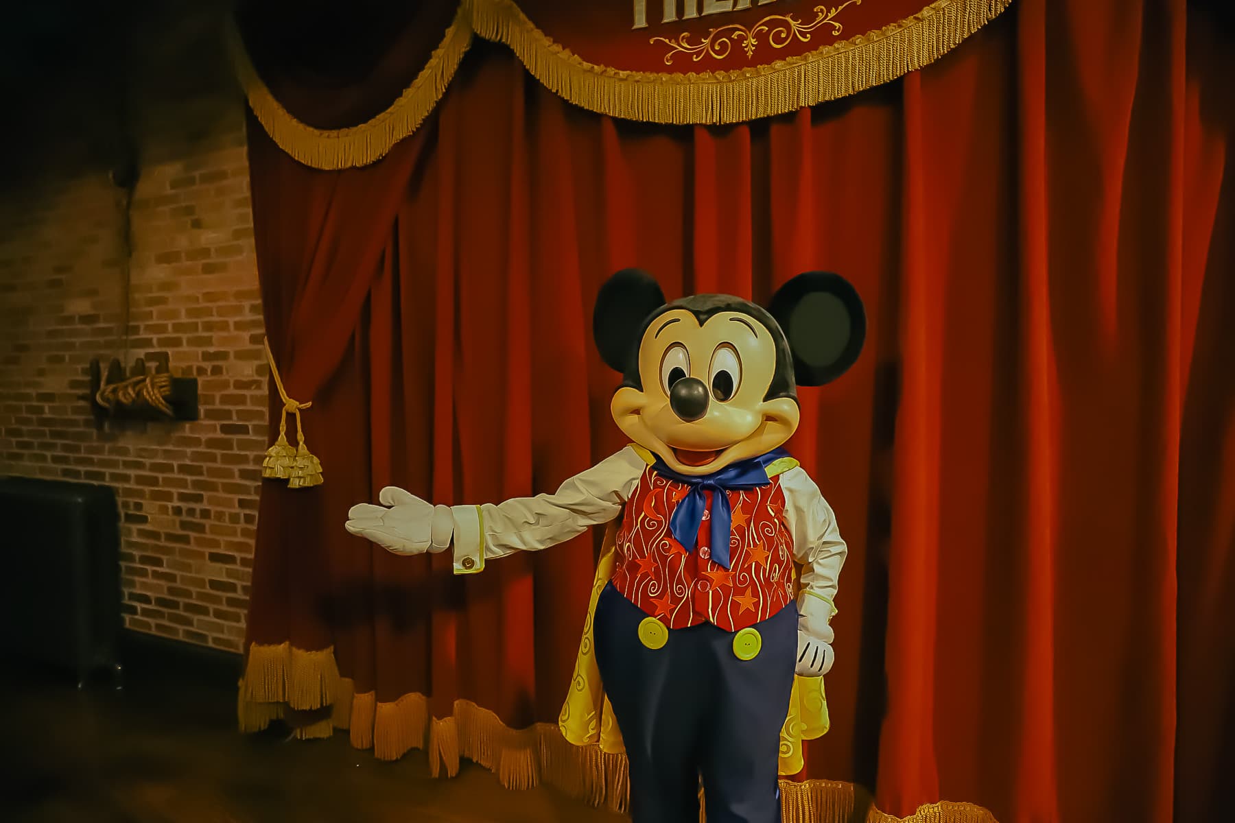 Mickey with his arm out as he poses in Town Square Theater. 