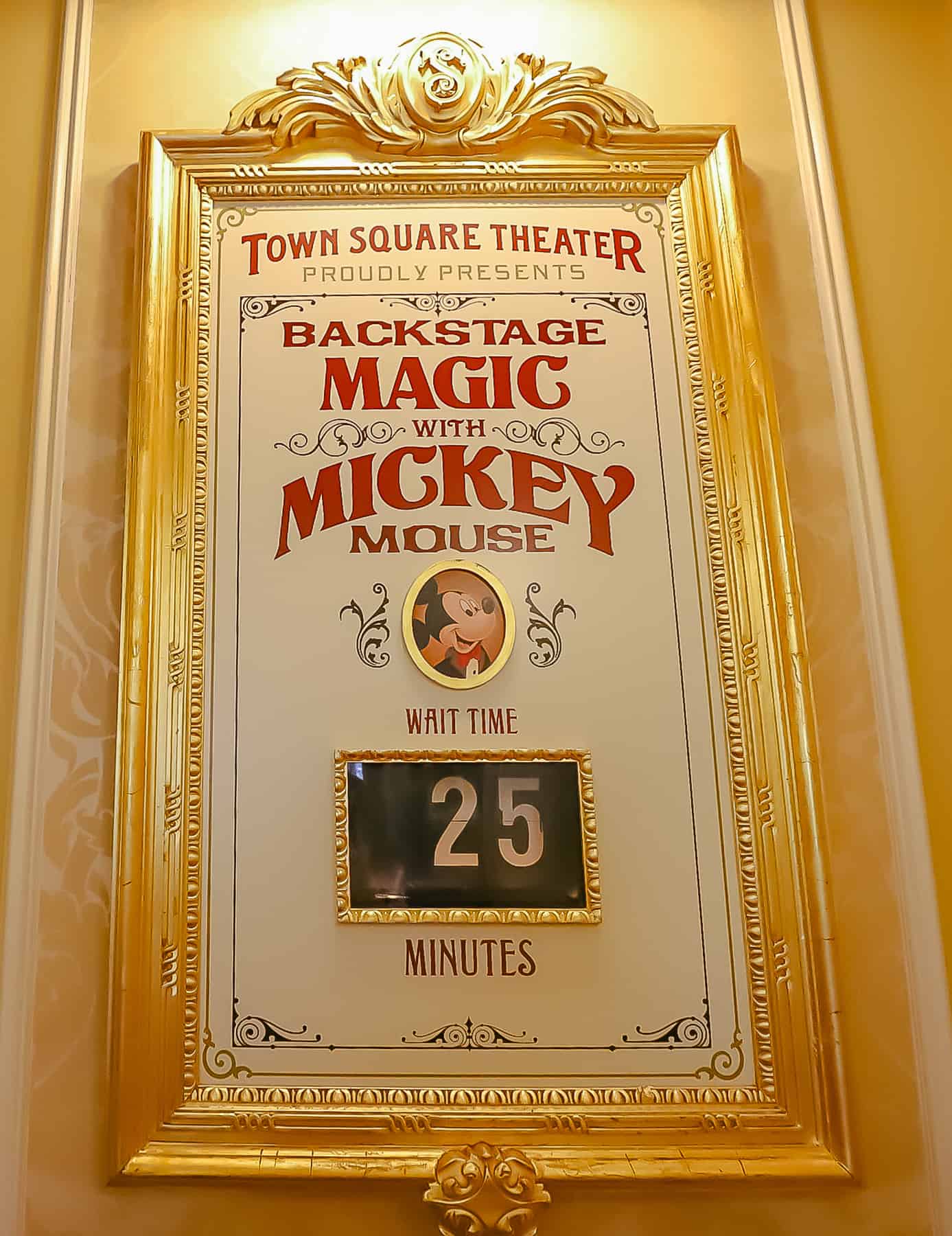 sign with wait times to go backstage with Mickey Mouse at Town Square Theater