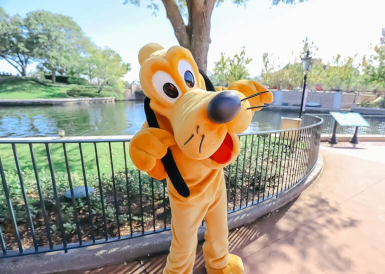 Pluto poses for a photo at Epcot's International Gateway.