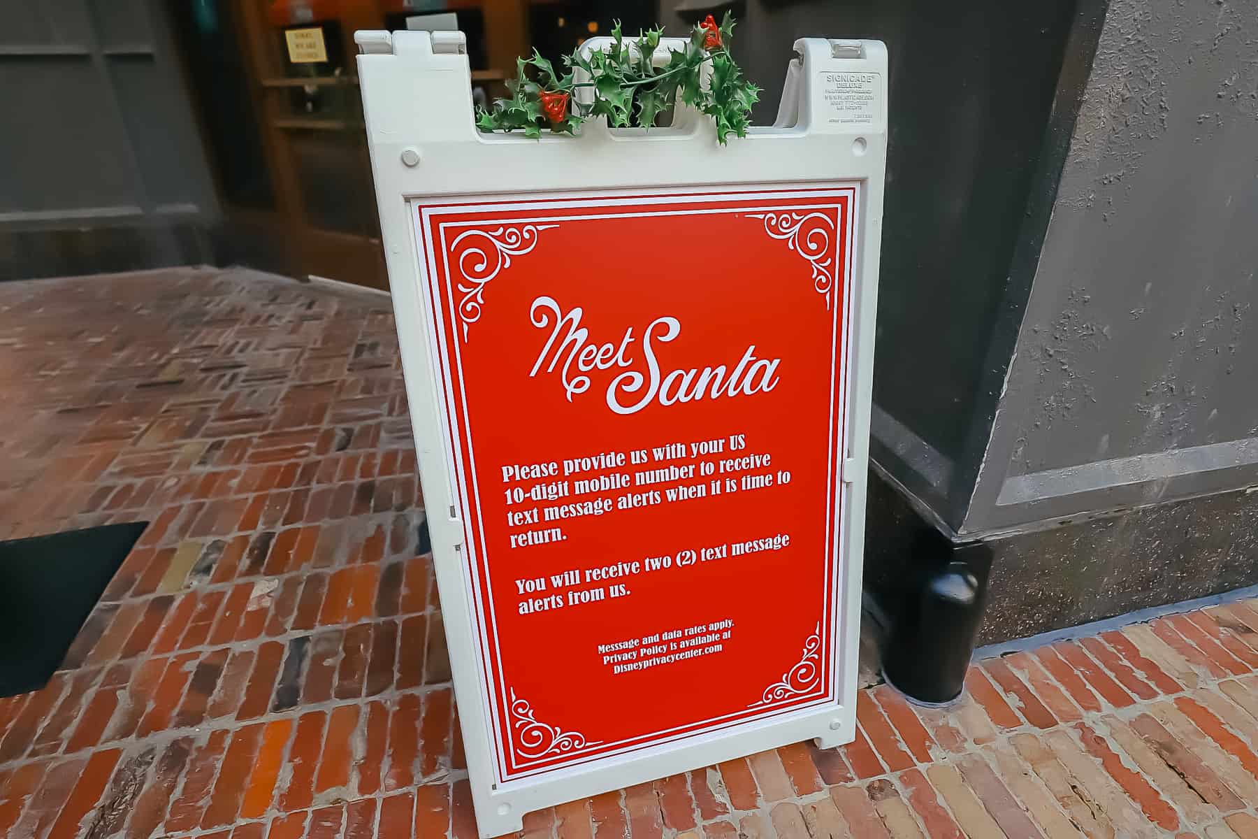 Sign that says, "Meet Santa" Please provide us with your US 10-digit mobile number to receive text message alerts when it's time to return. 