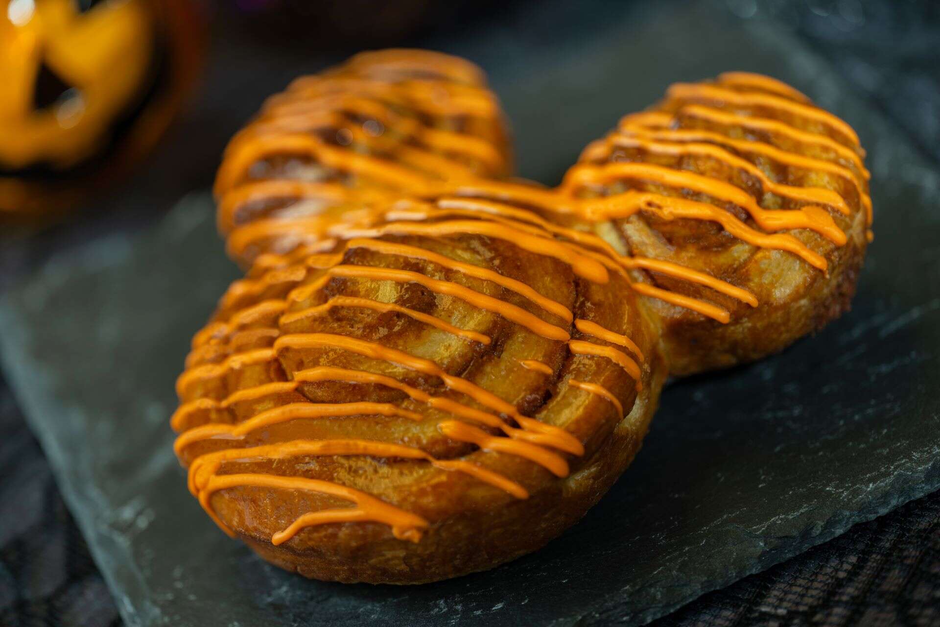 a cinnamon roll with orange icing