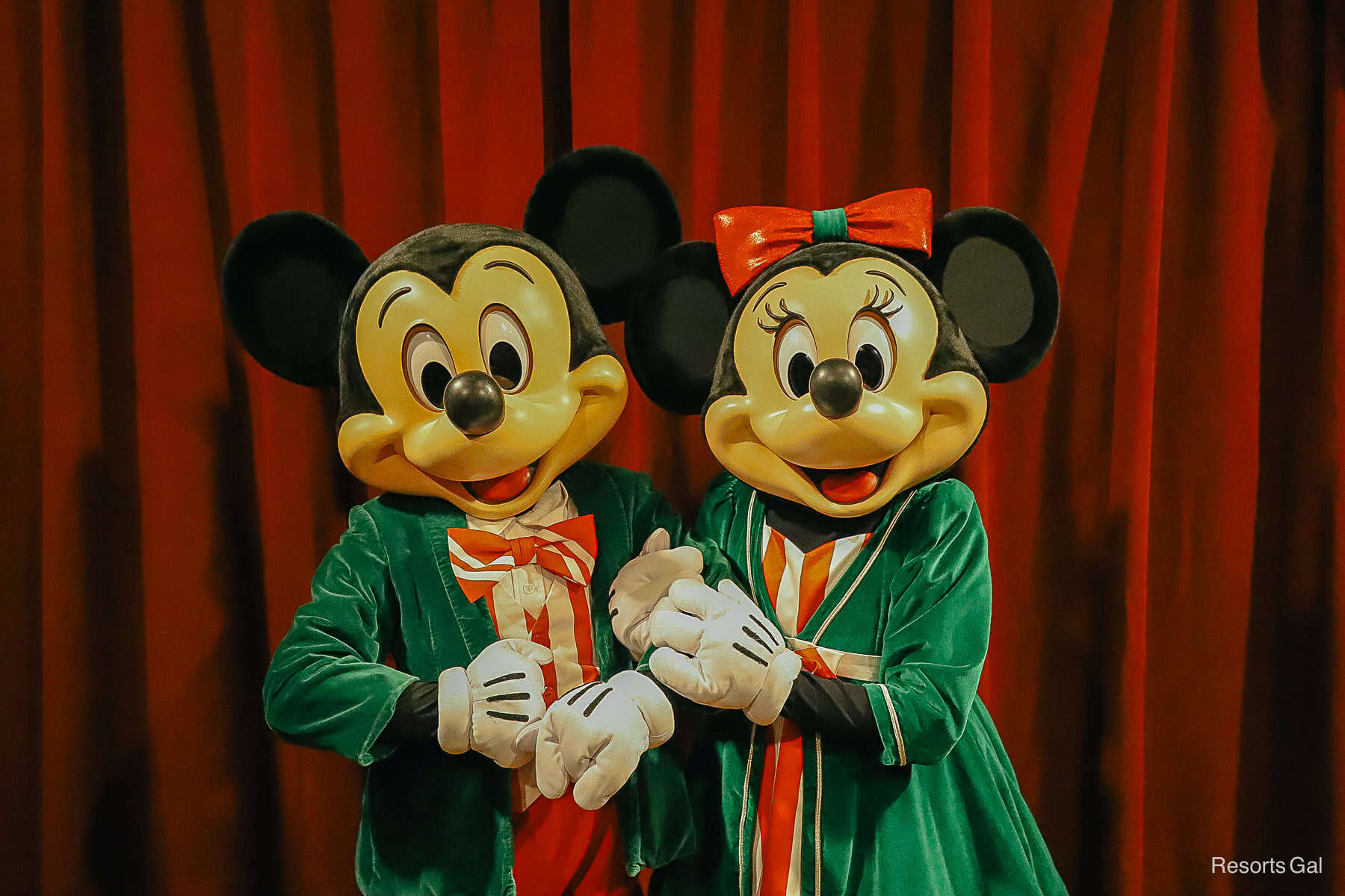 Mickey and Minnie Mouse with Minnie's arm wrapped around Mickey's 