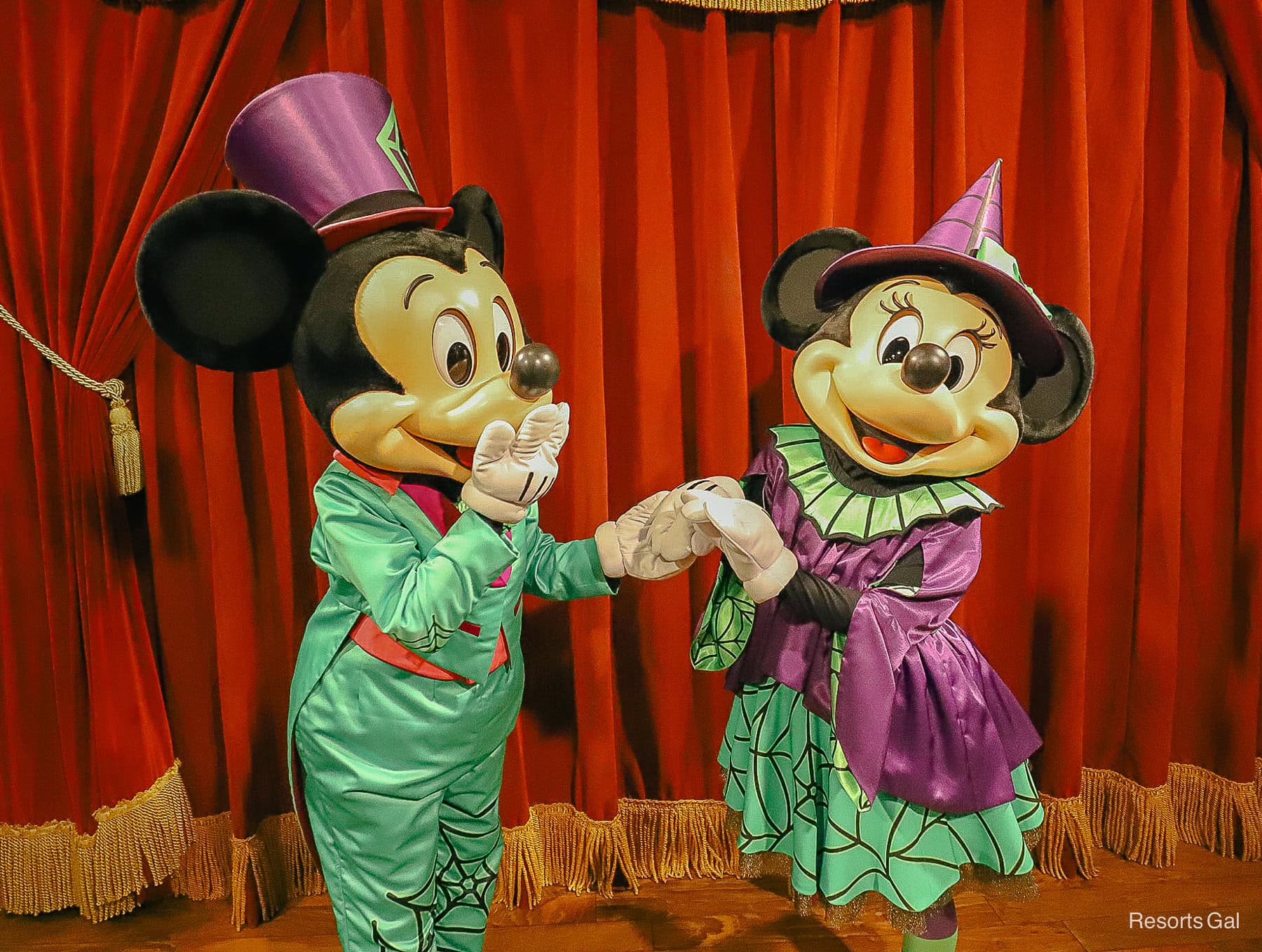 Mickey giggling with Minnie with hand over mouth