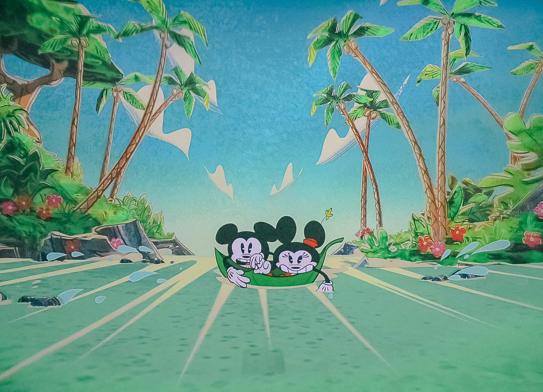 Mickey and Minnie are in a leaf that's about to go over a waterfall. 