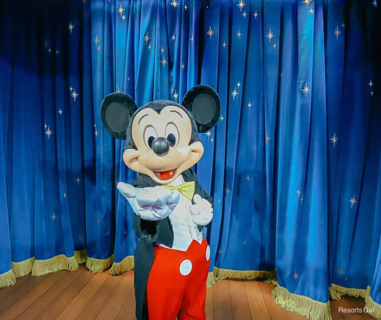 Mickey Mouse with hand extended.