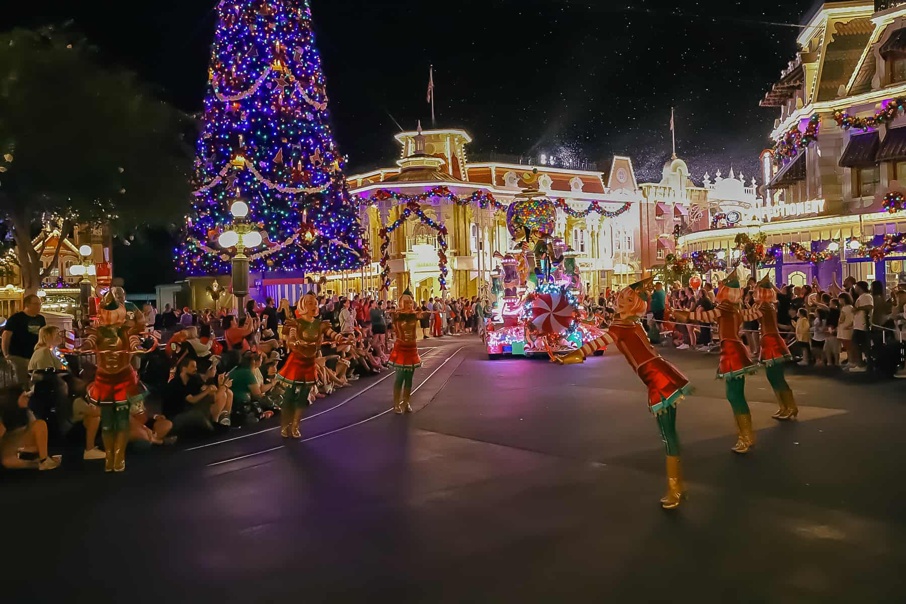 Dancers ahead of Goofy's candy float. 