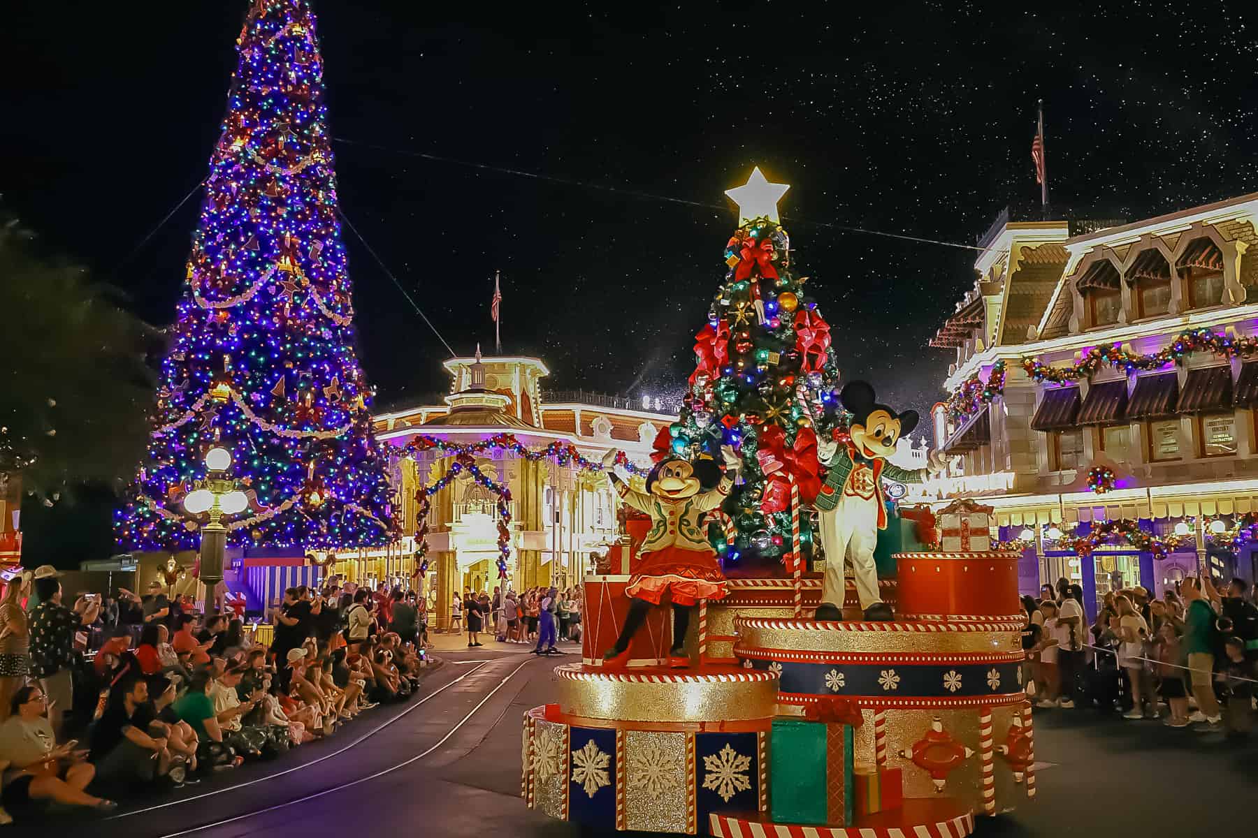 Mickey and Minnie Mouse ride on a Disney World Christmas Parade float. 