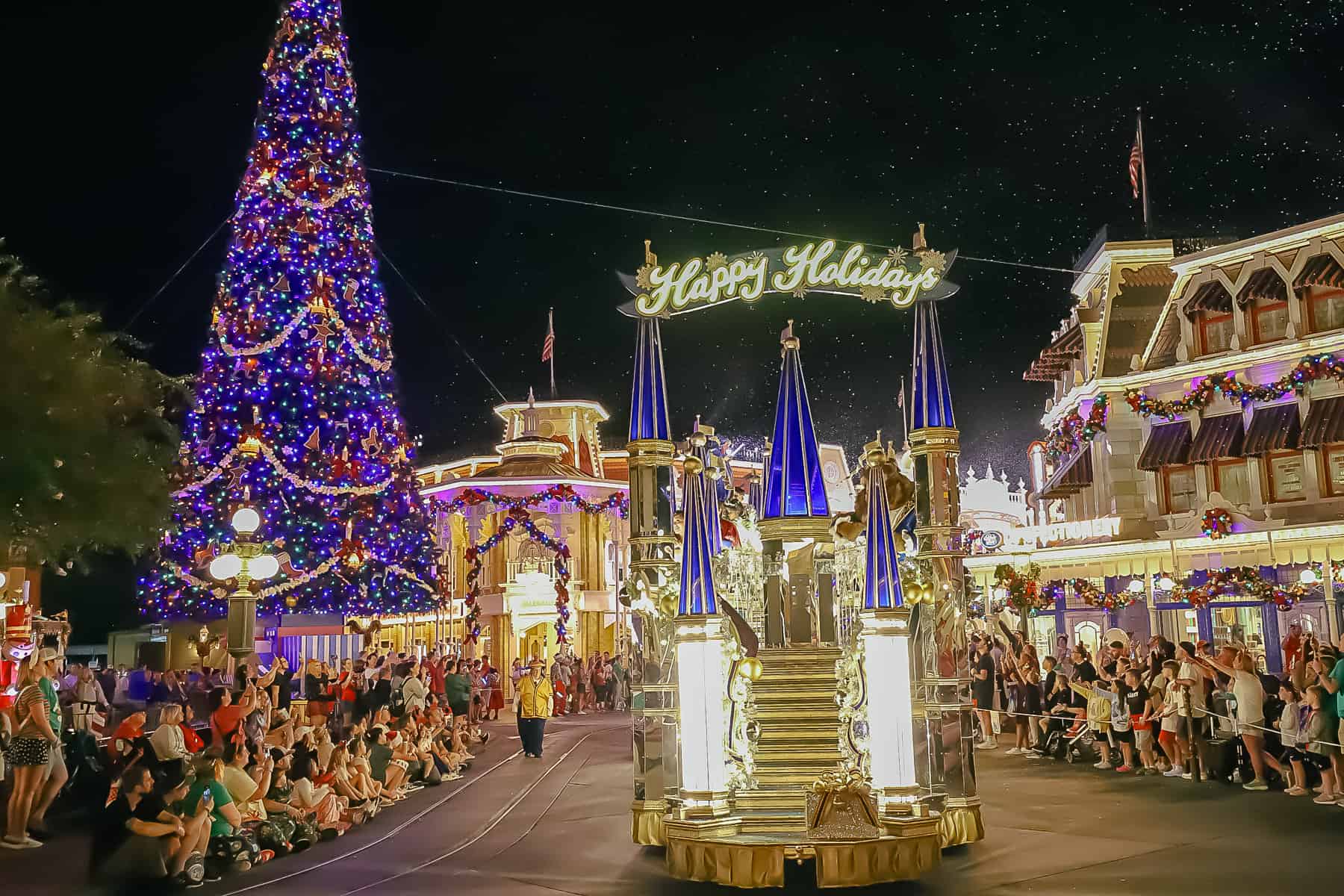 Princess Float with mirrors that says Happy Holidays at night. 