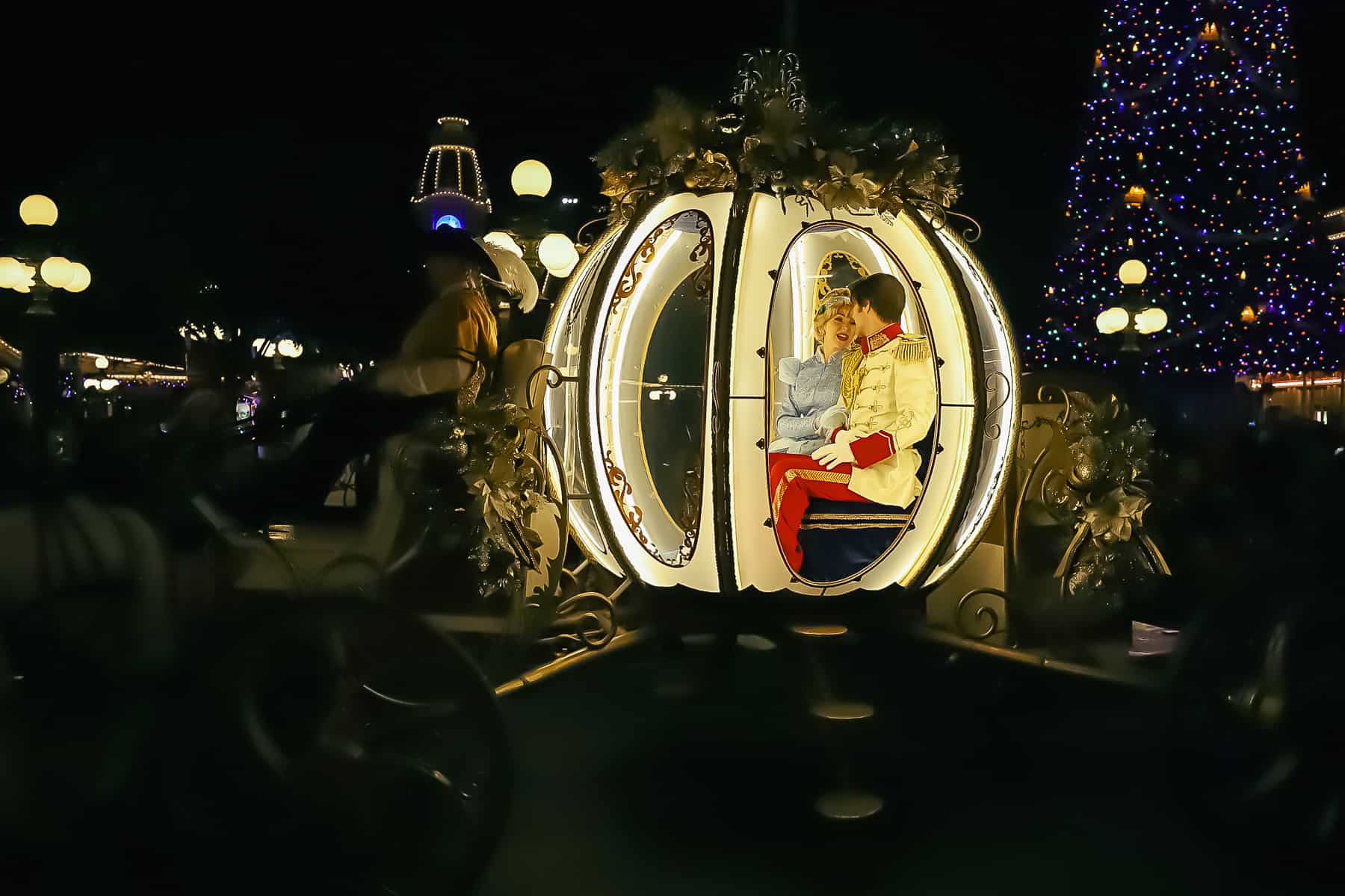 Cinderella and Prince Charming inside her glowing carriage during the Christmas Parade. 