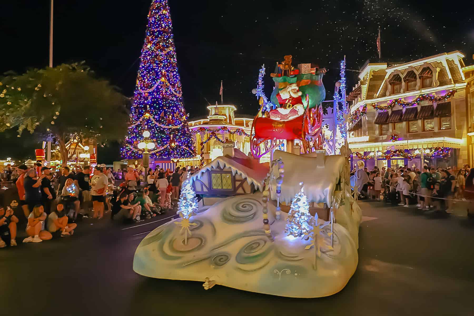 Santa riding by himself in the evening parade. 