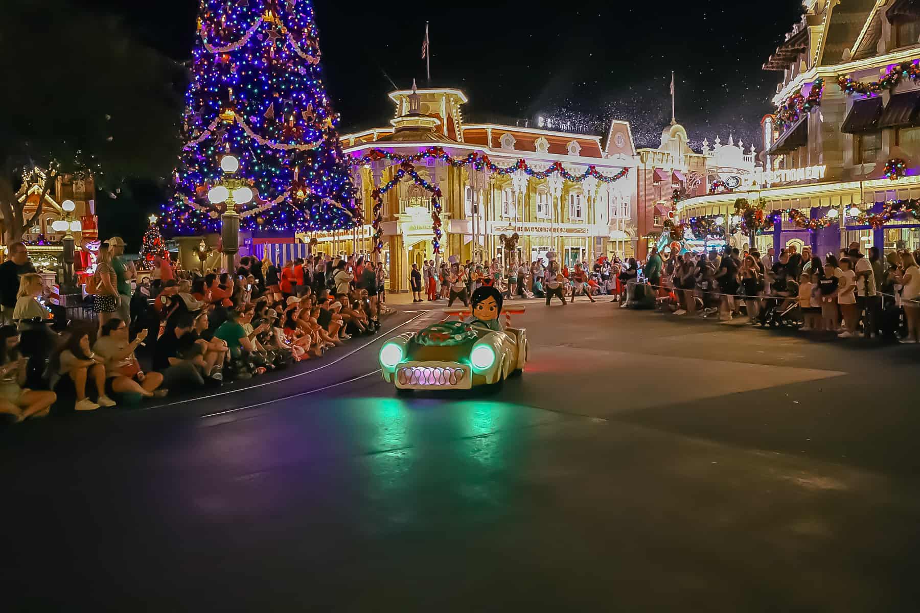 Vanellope Von Schweetz drives a gingerbread car in the Christmas Parade. 