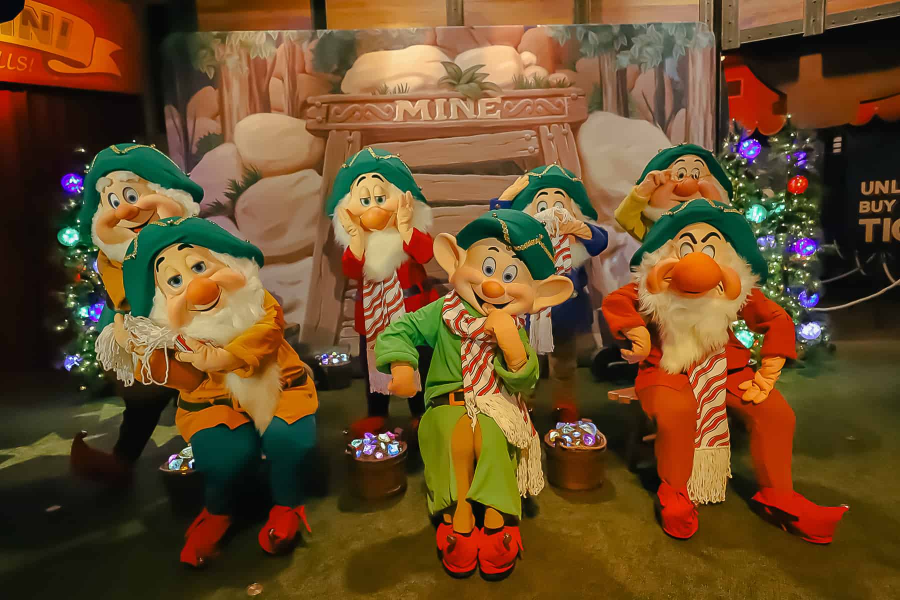 The Seven Dwarfs in a Christmas setting with scarves and gold trimmed hats. 