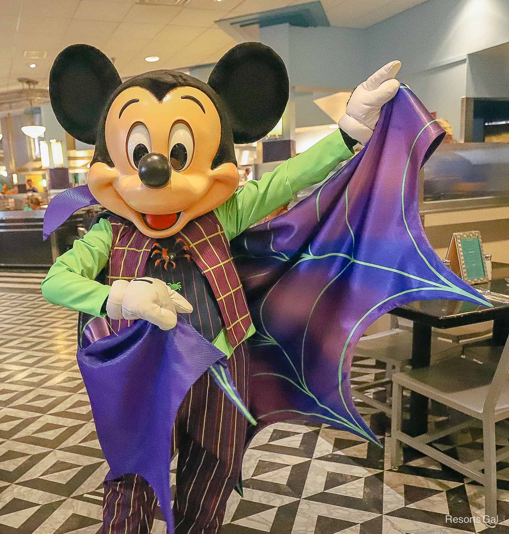 Mickey Mouse shows off his cape. 