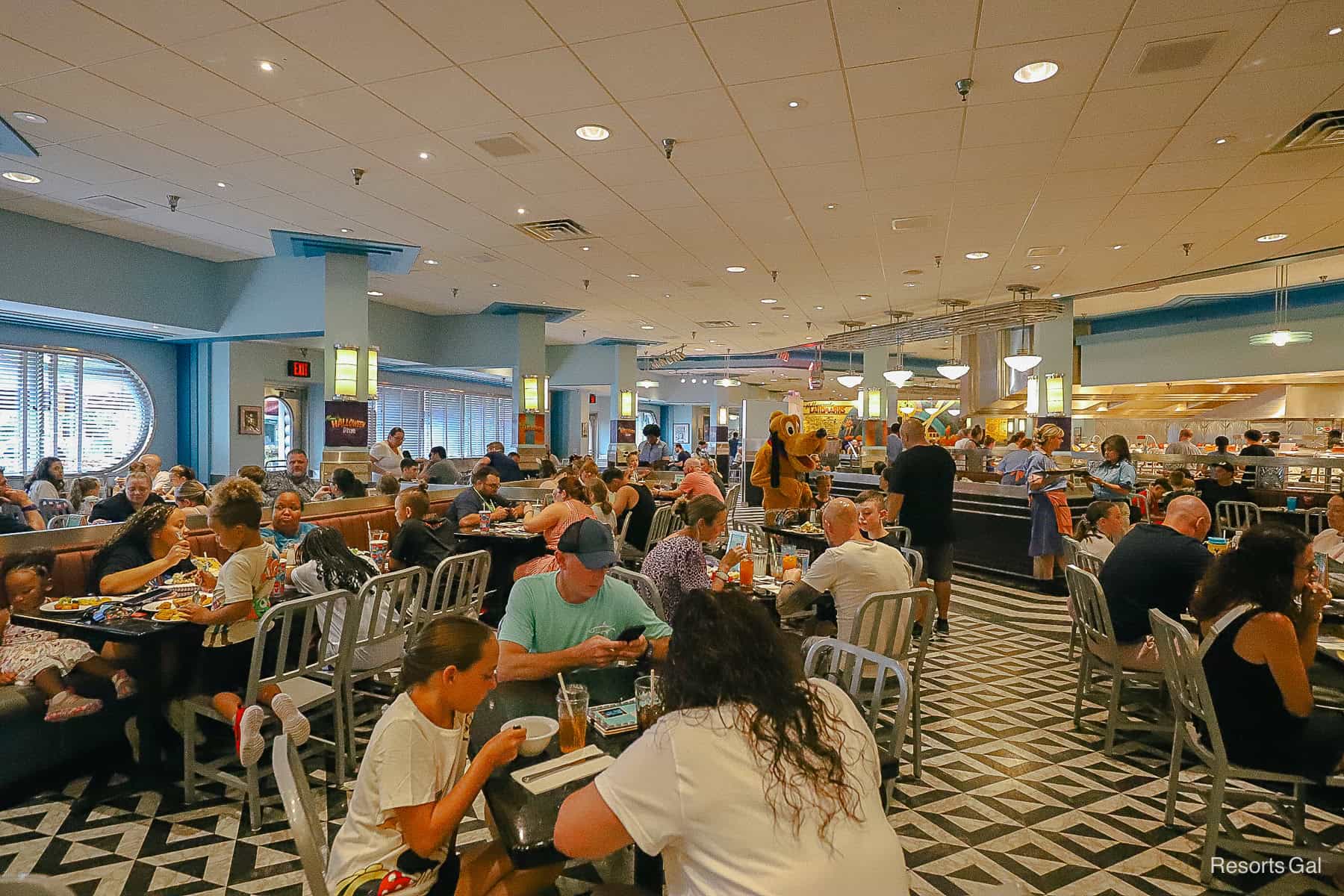 guests in the dining room waiting on characters to come to their table at Minnie's Seasonal Dine 