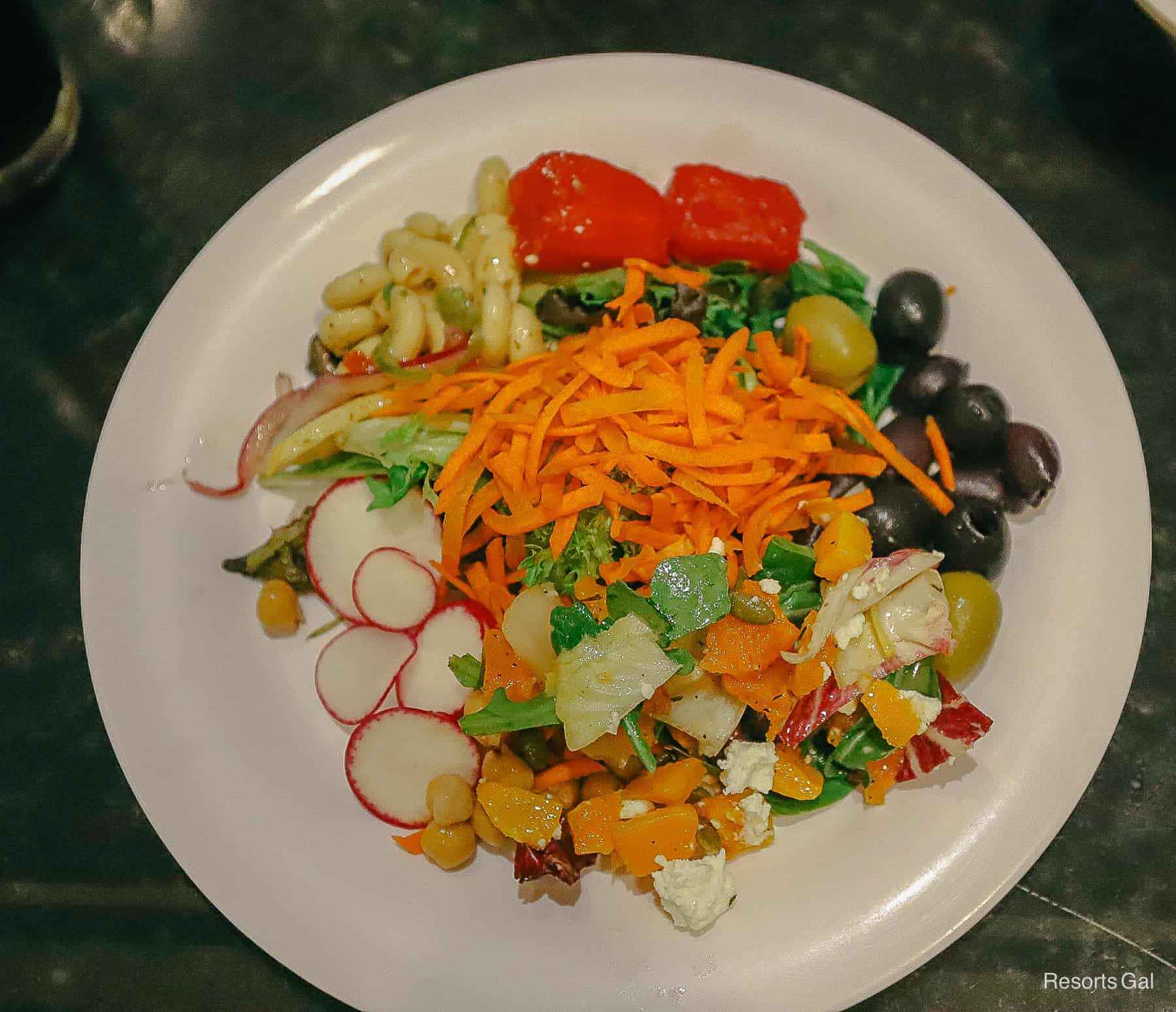 shows salad, pasta salad, watermelon salad, olives, and an autumn mix salad 