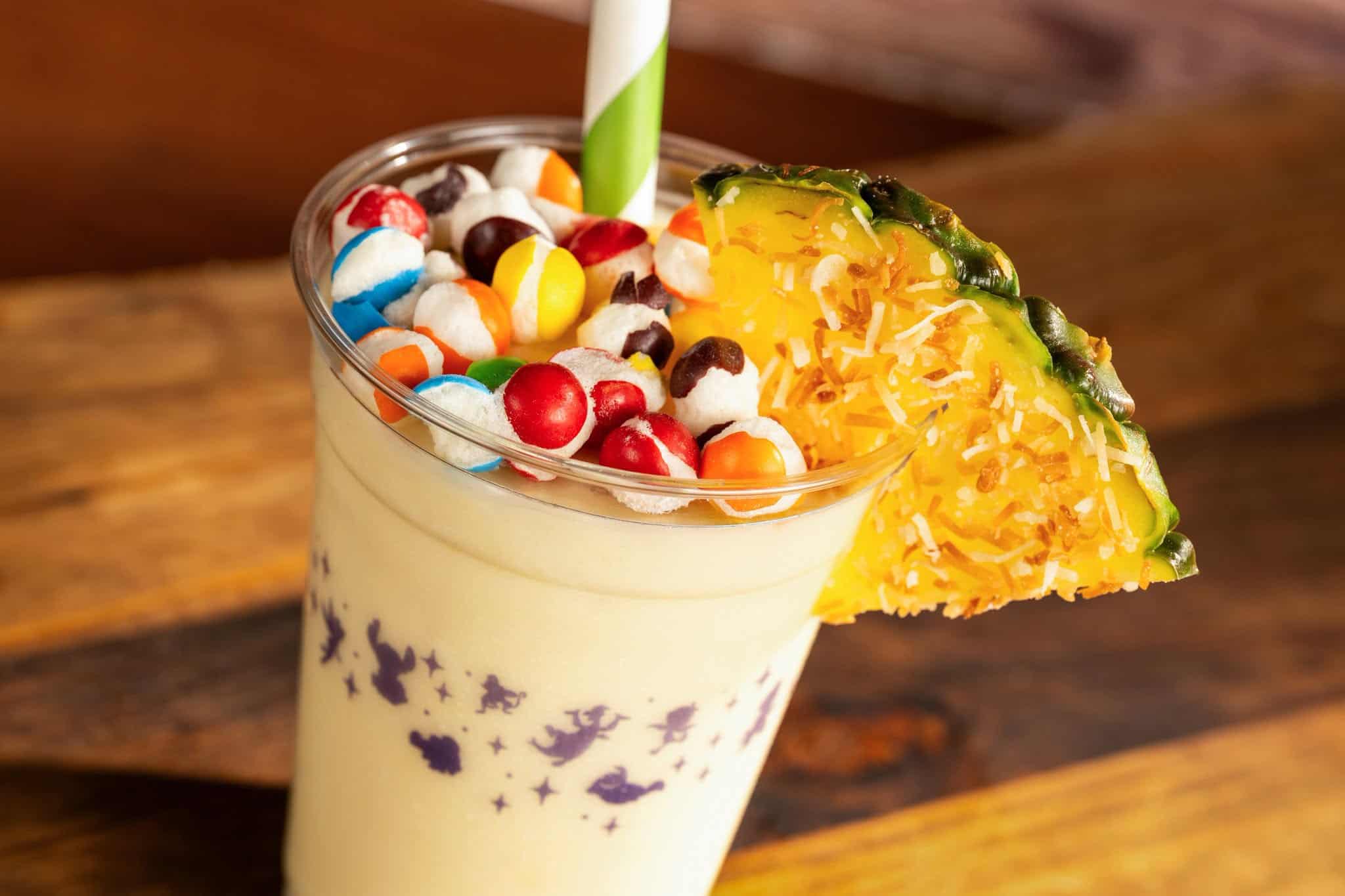 a frozen drinked topped with a pineapple slice and Skittles