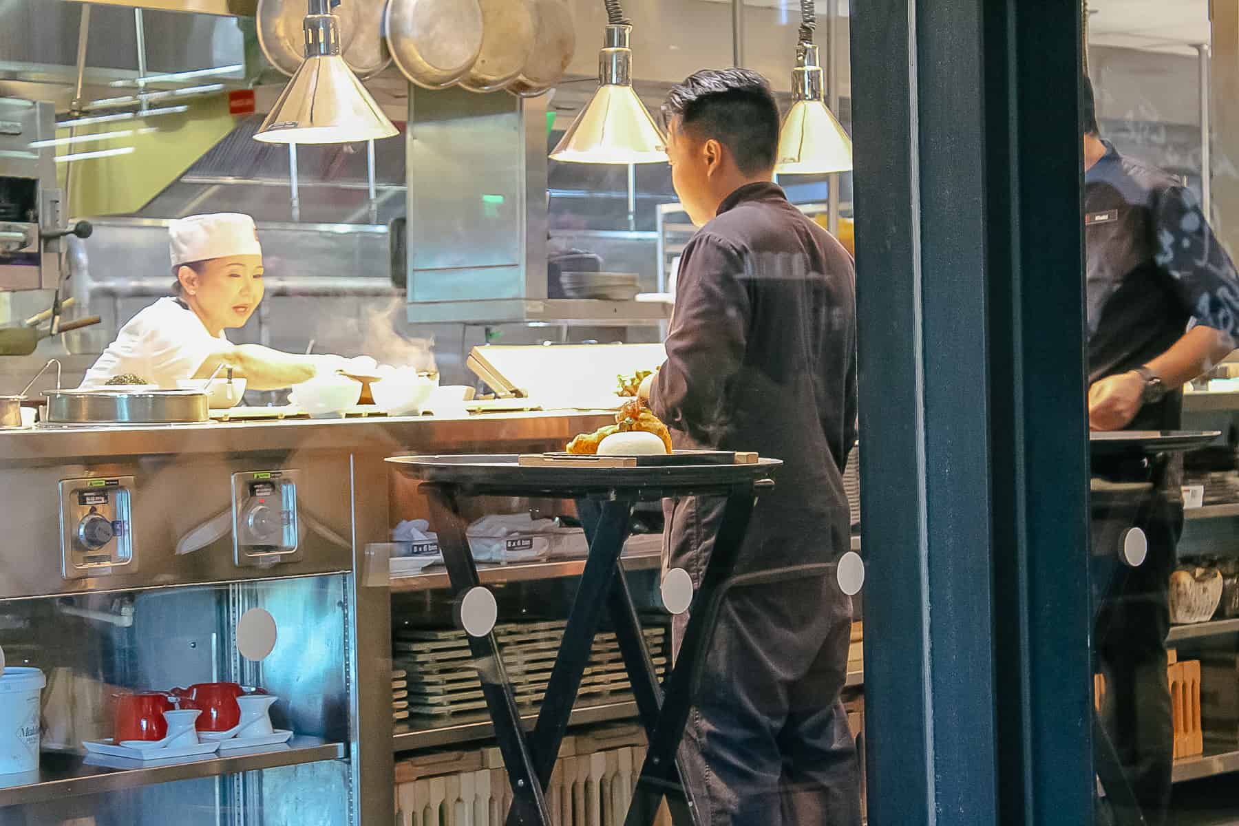 chefs working inside the kitchen at Morimoto Asia 