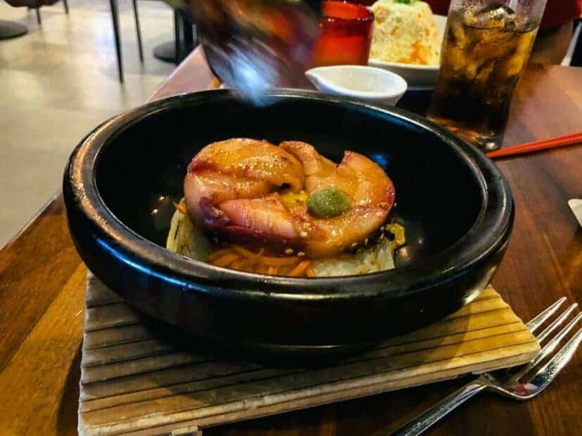 Server preparing Buri Bop at the table.