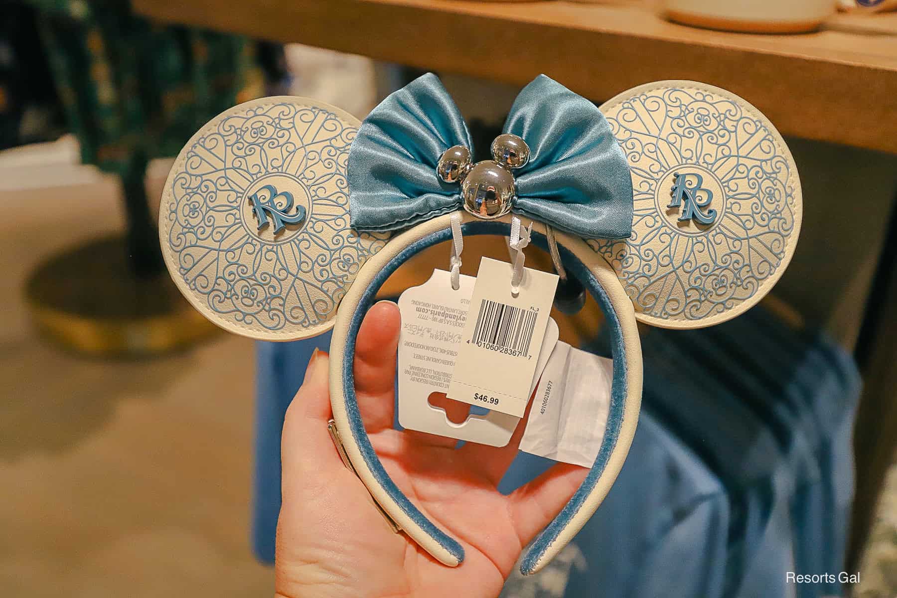 a pair of Minnie Ears that are white and blue with the RR logo for Riviera Resort on each ear