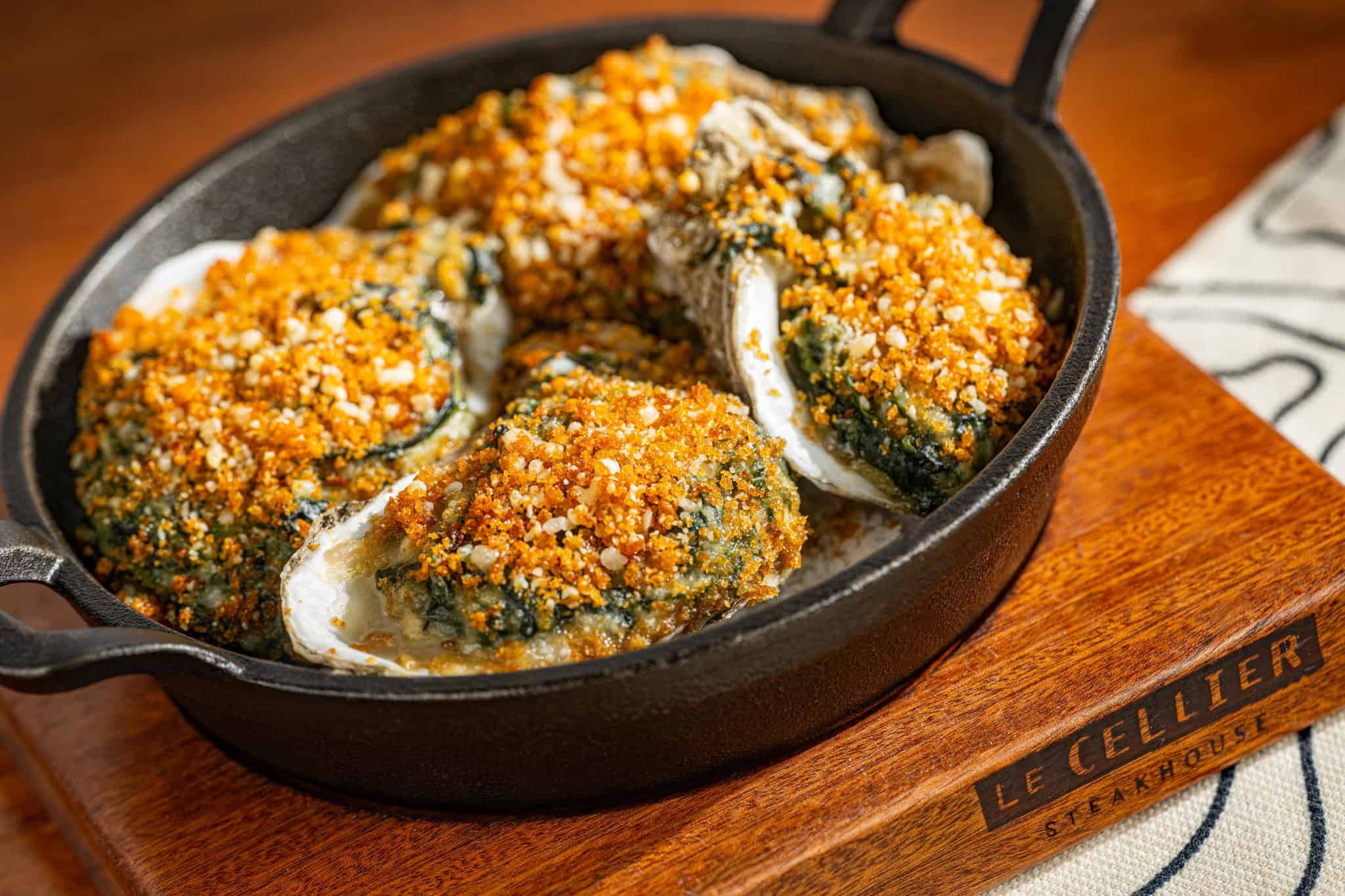 a cast iron skillet with oysters Rockefeller