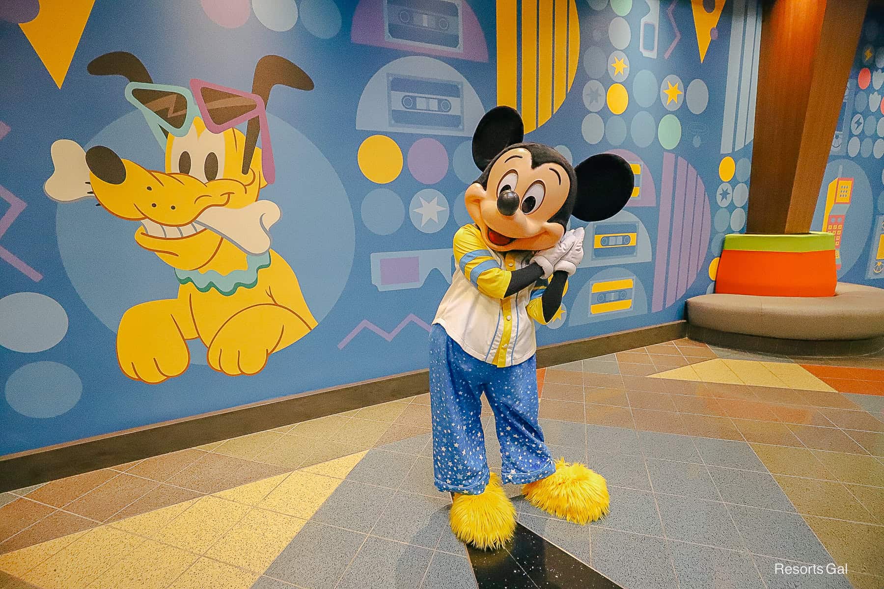 Mickey Mouse with a sleeping post in blue and yellow pajamas