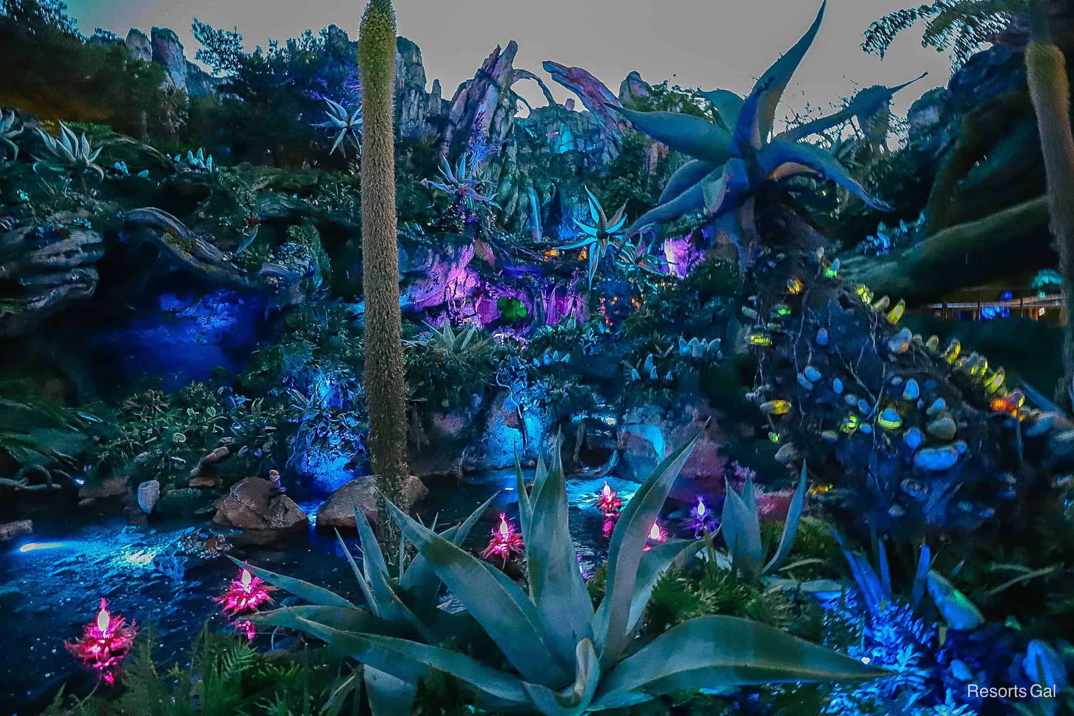 the mountain of Pandora at night with glowing plants in vibrant colors 