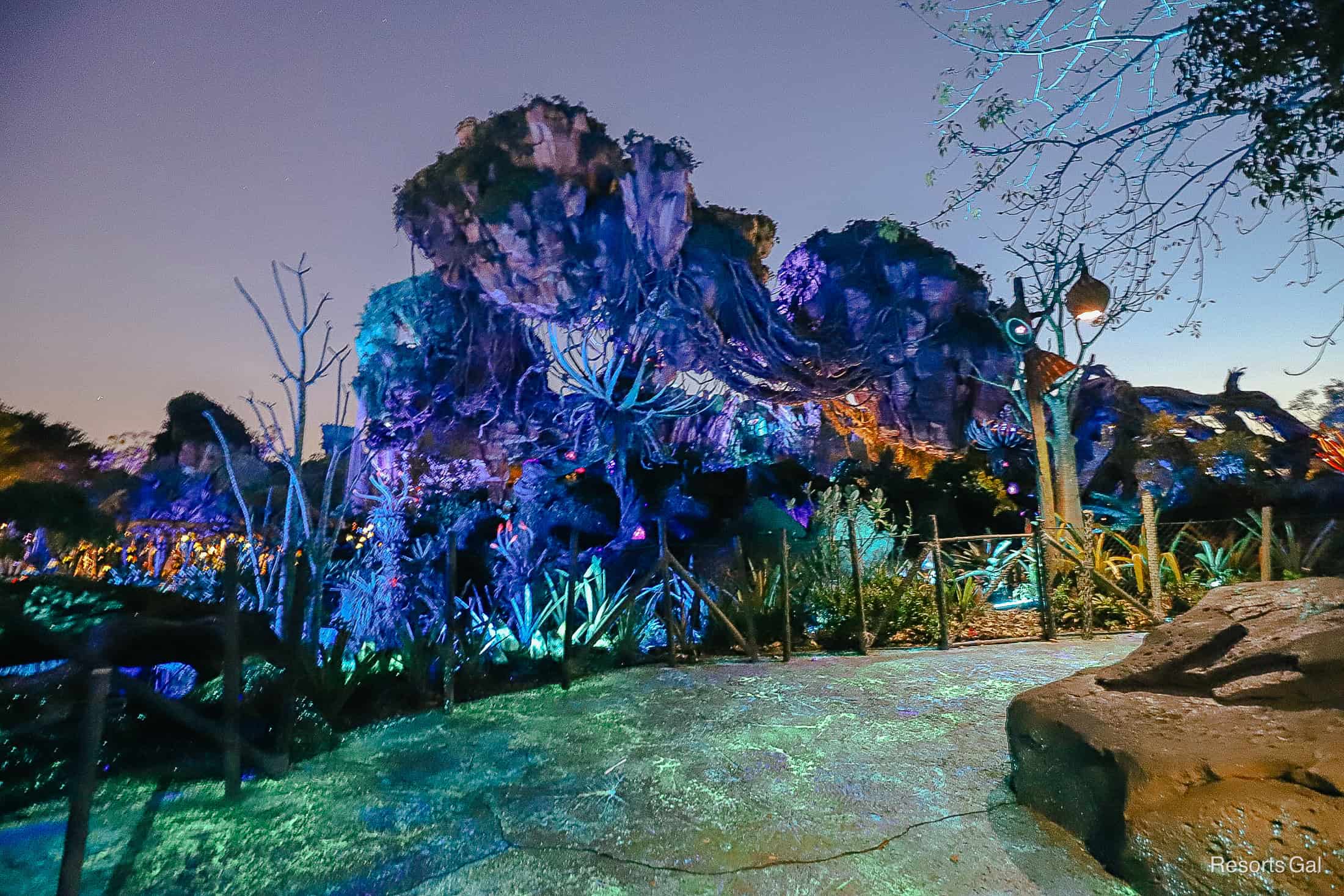 a scenic photo of the floating mountains of Pandora at night with purples and turquoise colors 